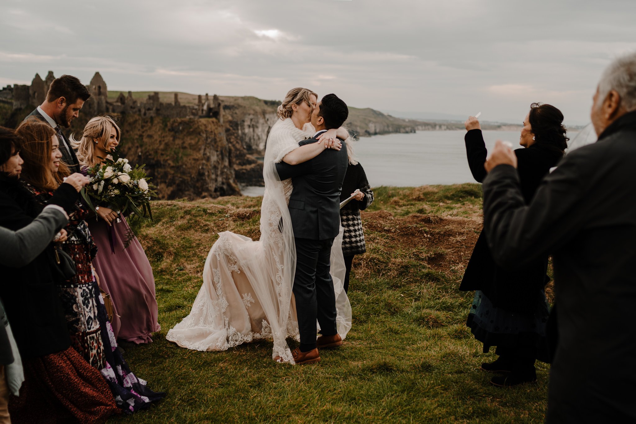 couple first kiss elopement at Dunluce castle cliff edge