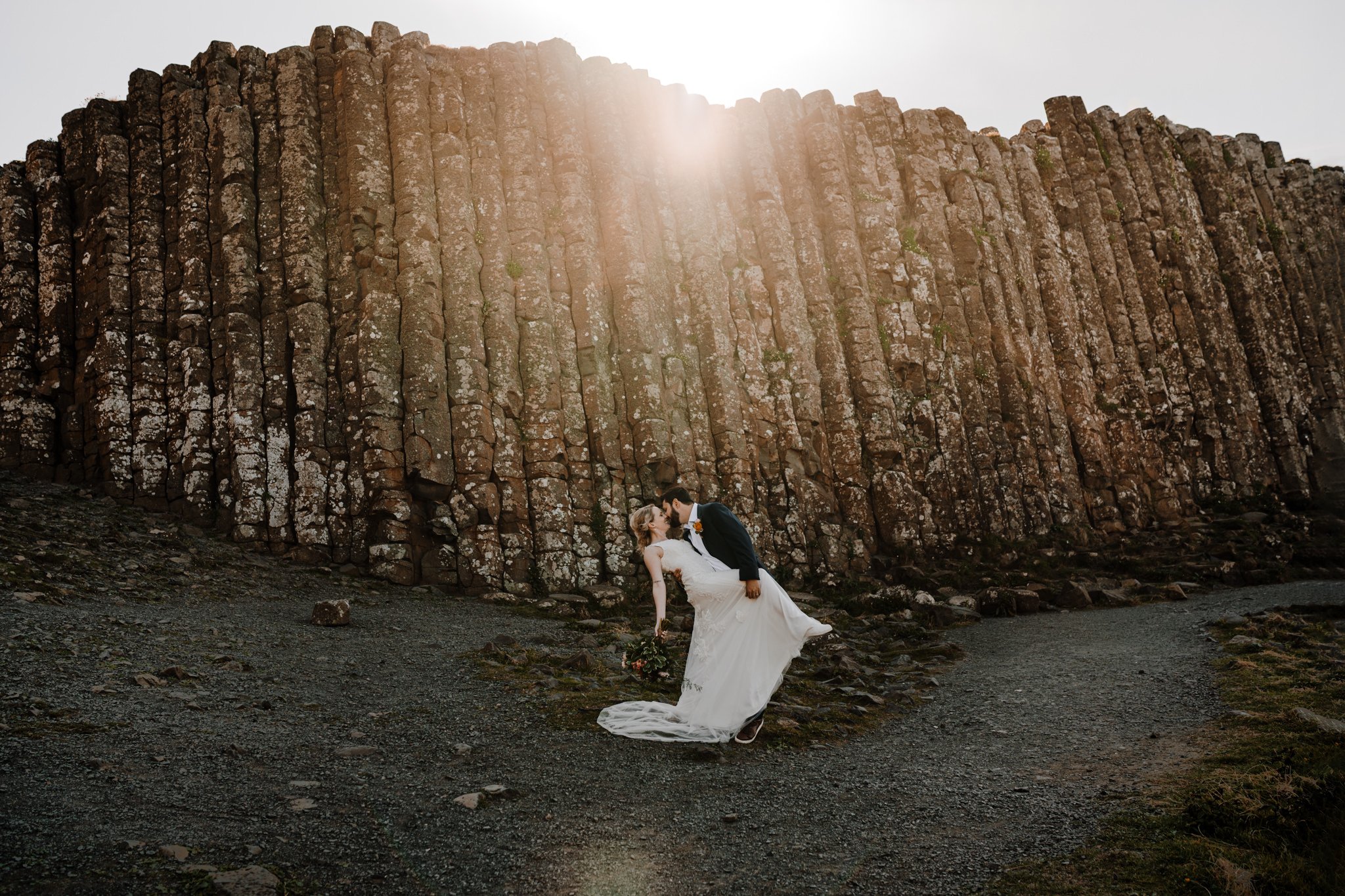 elopement couple kiss at sunset at giants causeway northern ireland