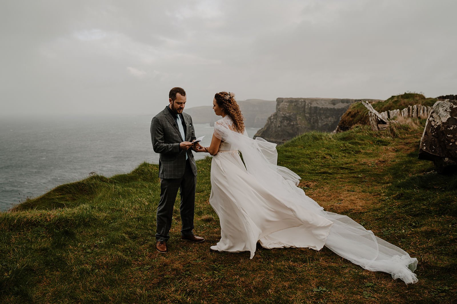  couple exchange vows during their elopement at the cliffs of Moher in the wind 