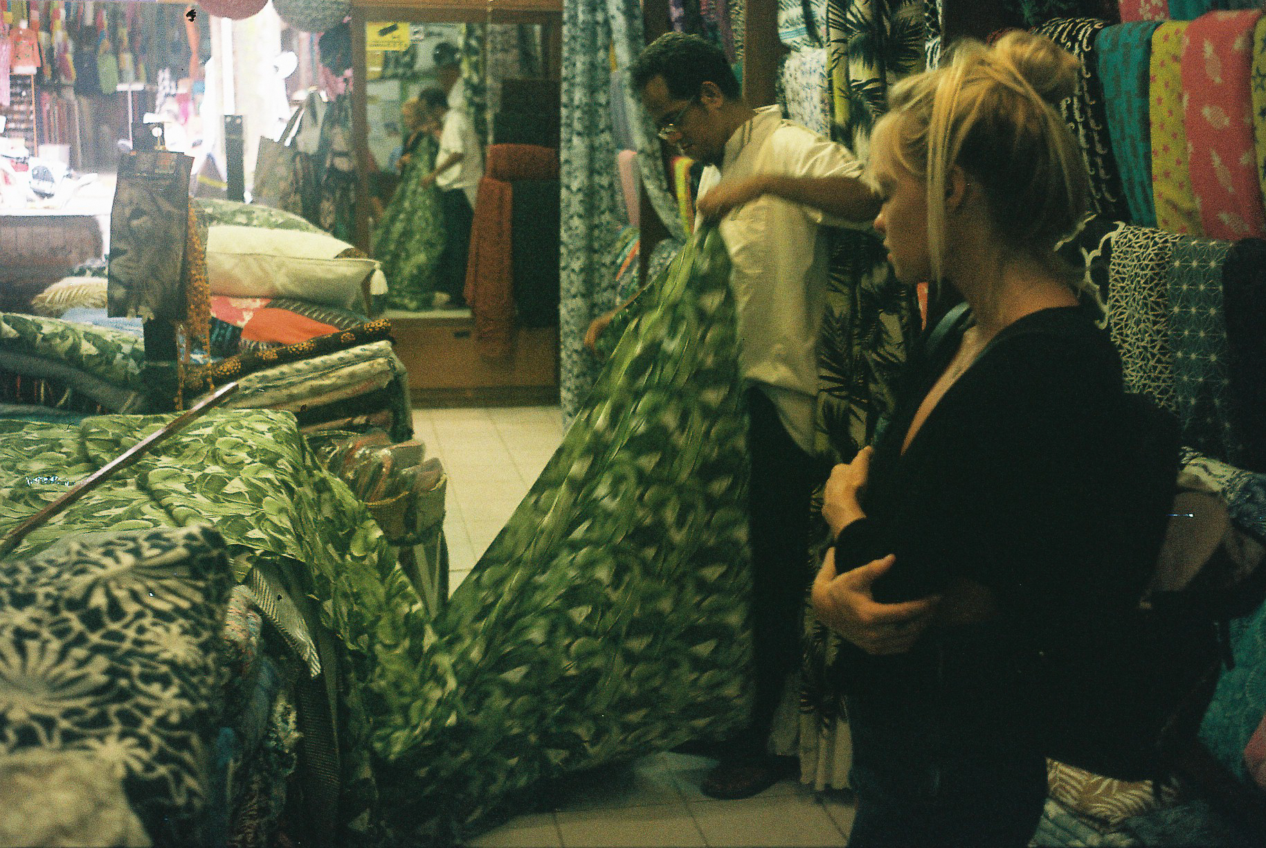 Taylor watches one of our local Balinese suppliers, Wayan, cut fabric to be used as lining for the 'Castaway' Rattan Bags.