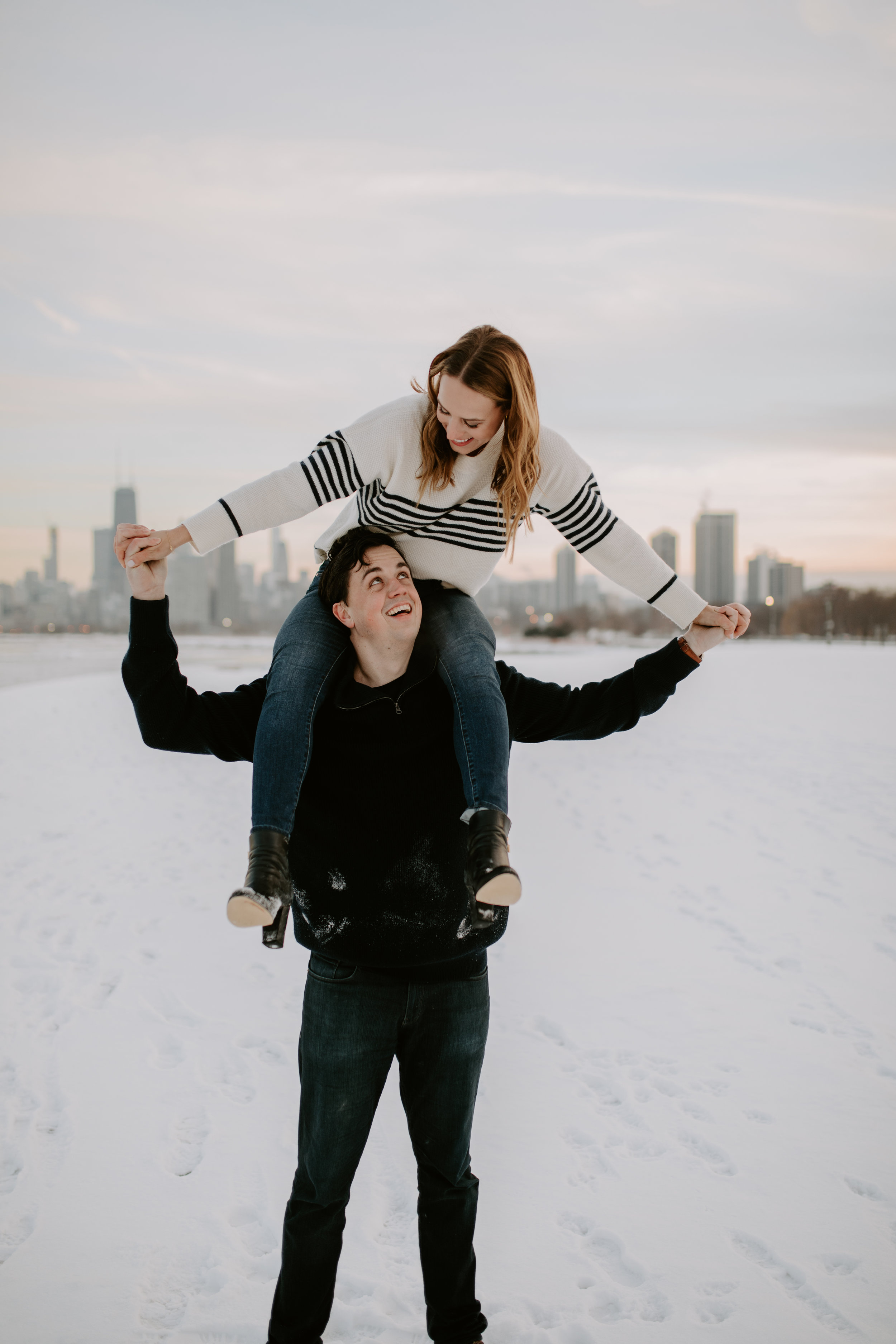 Winter engagement photo session with Chicago sunset at Chicago Lakefront, captured by Kerri Carlquist Photography. Find more inspiration at chitheewed.com!