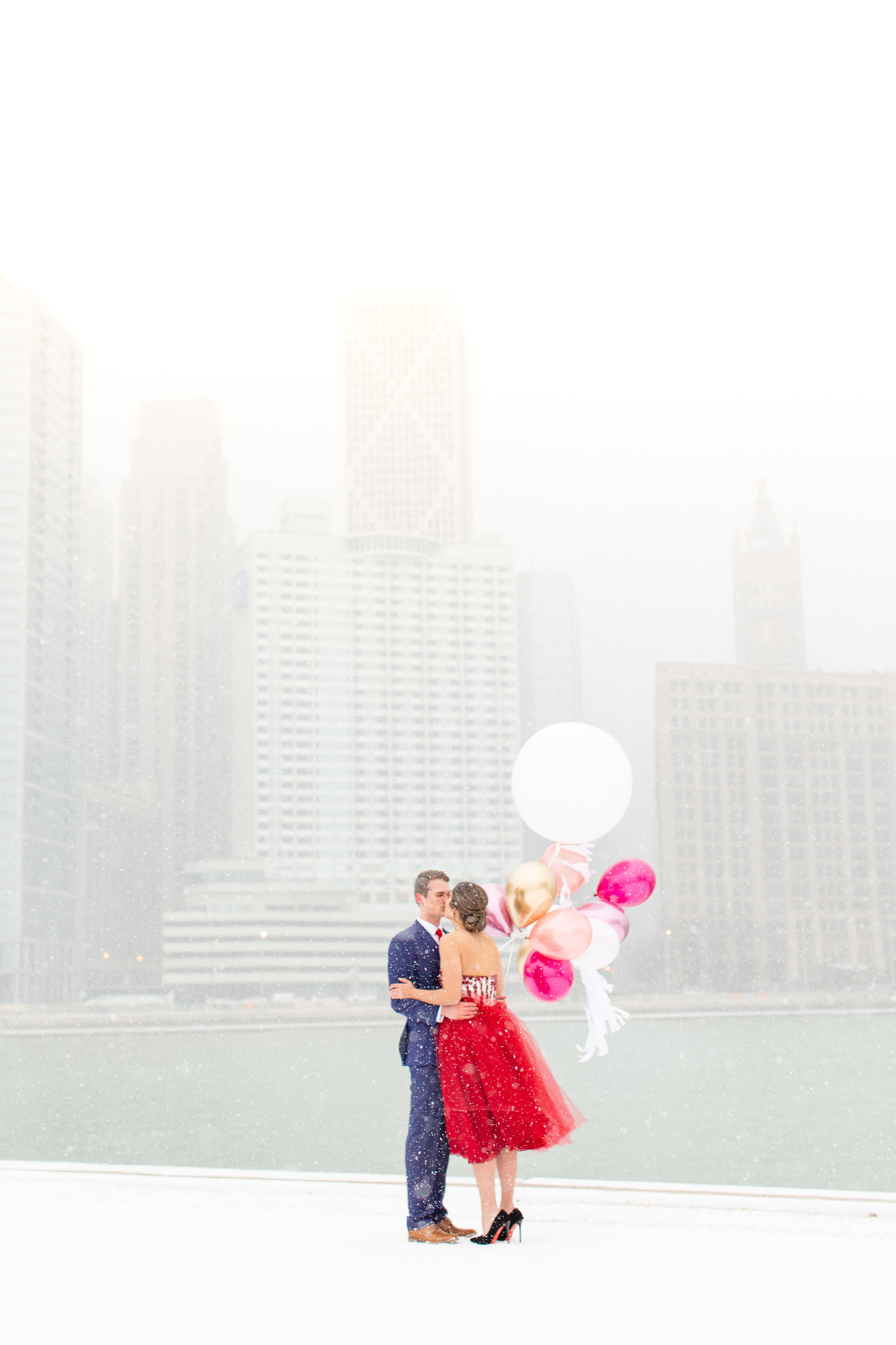 Snowy engagement photo styled shoot in downtown Chicago captured by Amy Mulder Photography. See more engagement photo ideas at CHItheeWED.com!