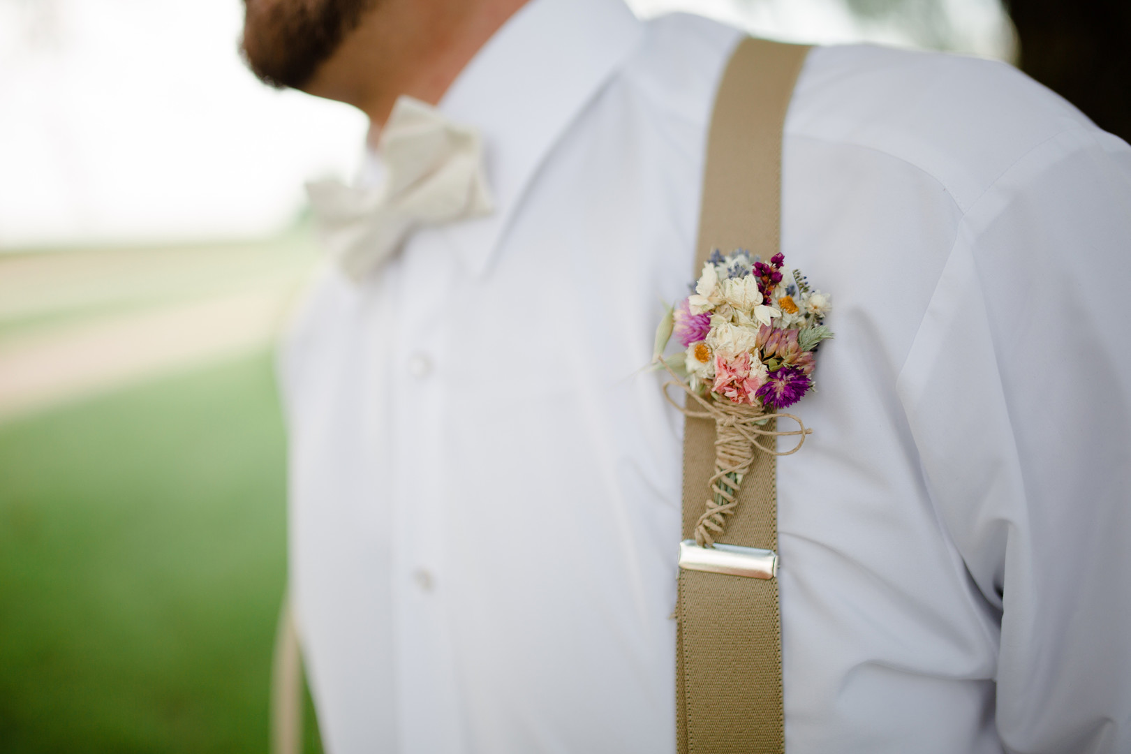 Groom's colorful wedding boutonniere: Rustic country wedding in Minooka, IL captured by Katie Brsan Photography. Visit CHItheeWED.com for more wedding inspiration!
