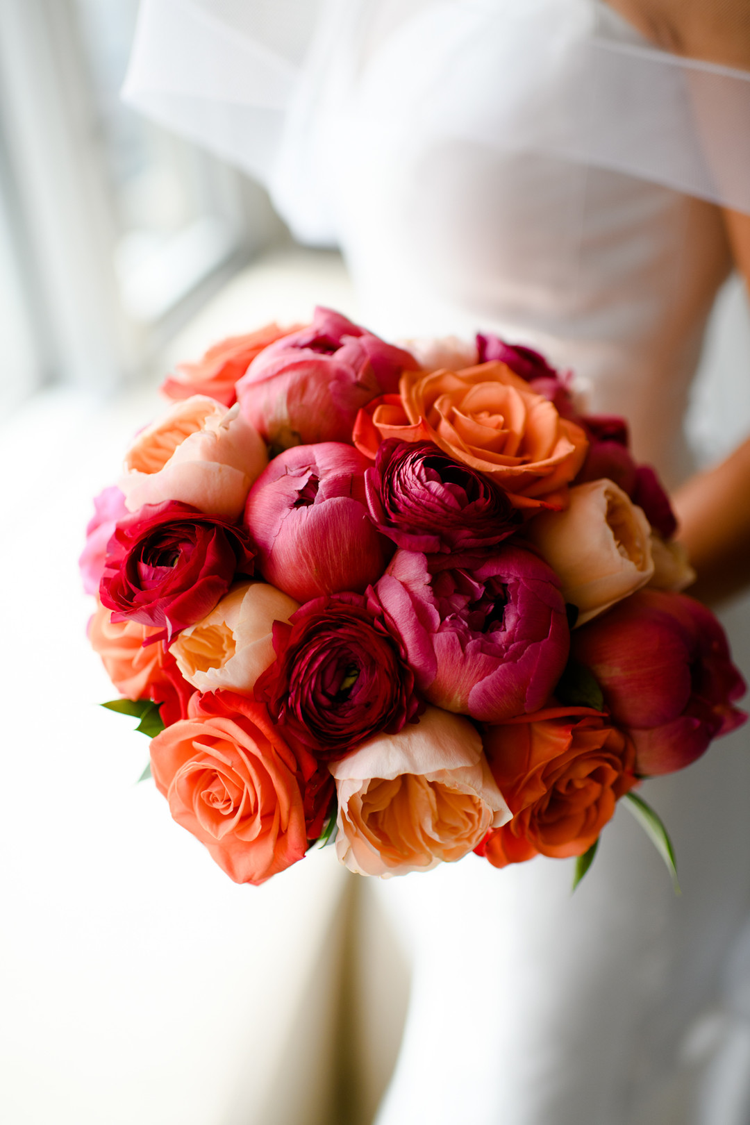 Pink and orange wedding bouquet: Timeless and colorful Chicago wedding in Lincoln Park captured by StudioThisIs. See more wedding ideas at CHItheeWED.com!