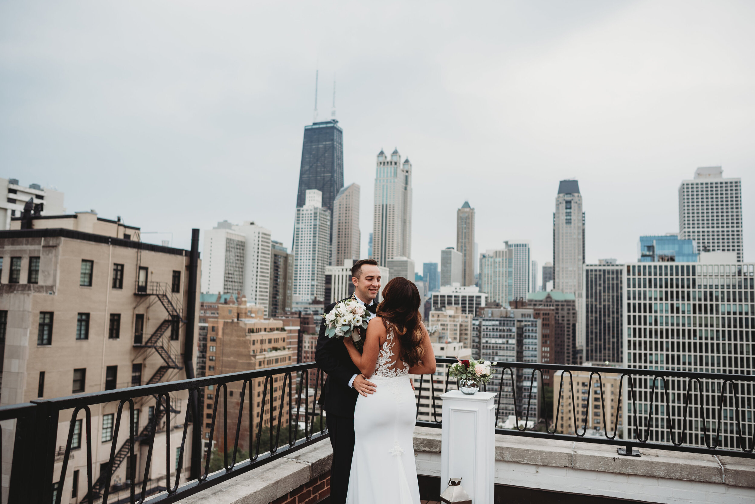 Chicago skyline wedding first look: Modern Chic Chicago History Museum Wedding captured by Girl with the Tattoos. See more wedding ideas at CHItheeWED.com!