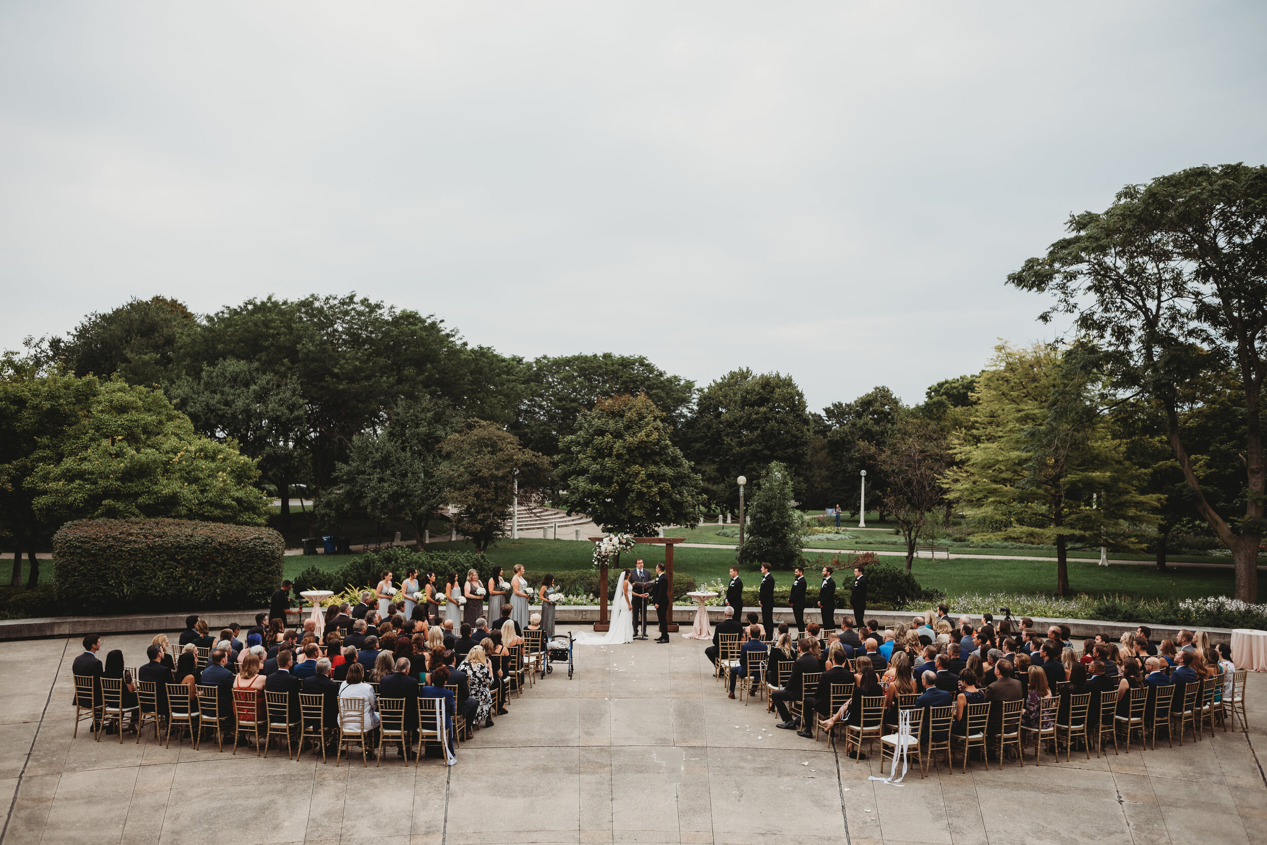 Outdoor wedding ceremony: Modern Chic Chicago History Museum Wedding captured by Girl with the Tattoos. See more wedding ideas at CHItheeWED.com!