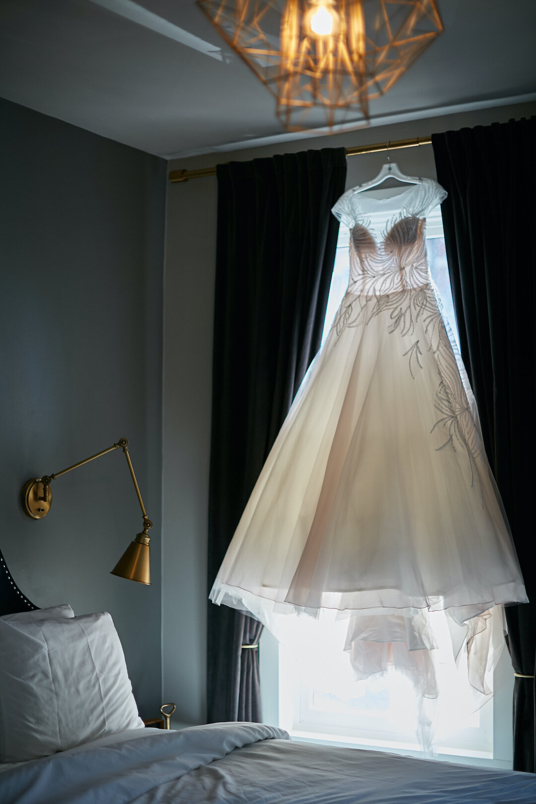 Wedding dress hanging in the window: Leap Day Wedding from Wicker Park Inn on CHI thee WED captured by Pure Wedding Day Photography 