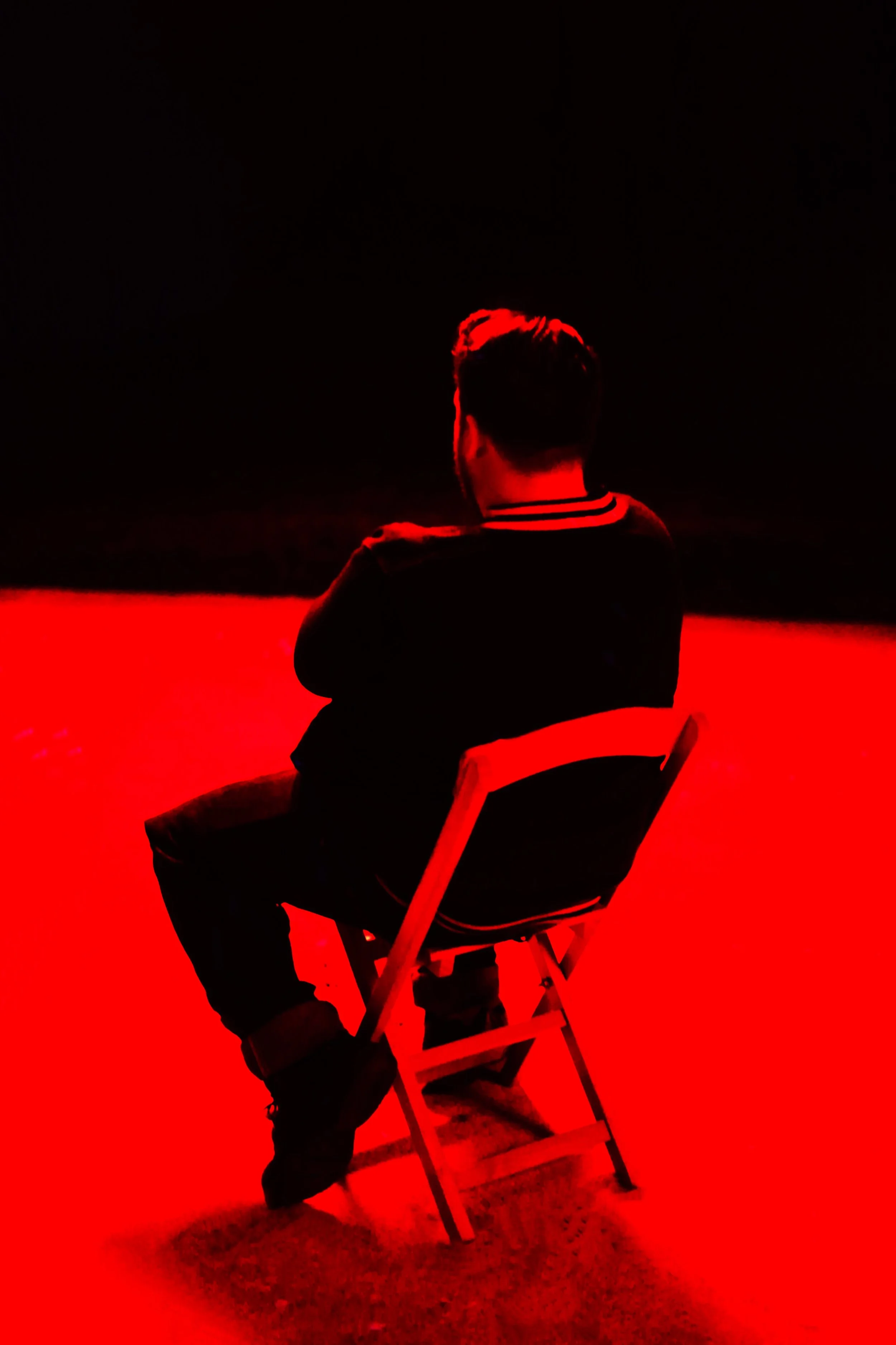 Saul Bass inspired spectator watching Virgin Cheerleaders in Chains at the Austin Film Project screening