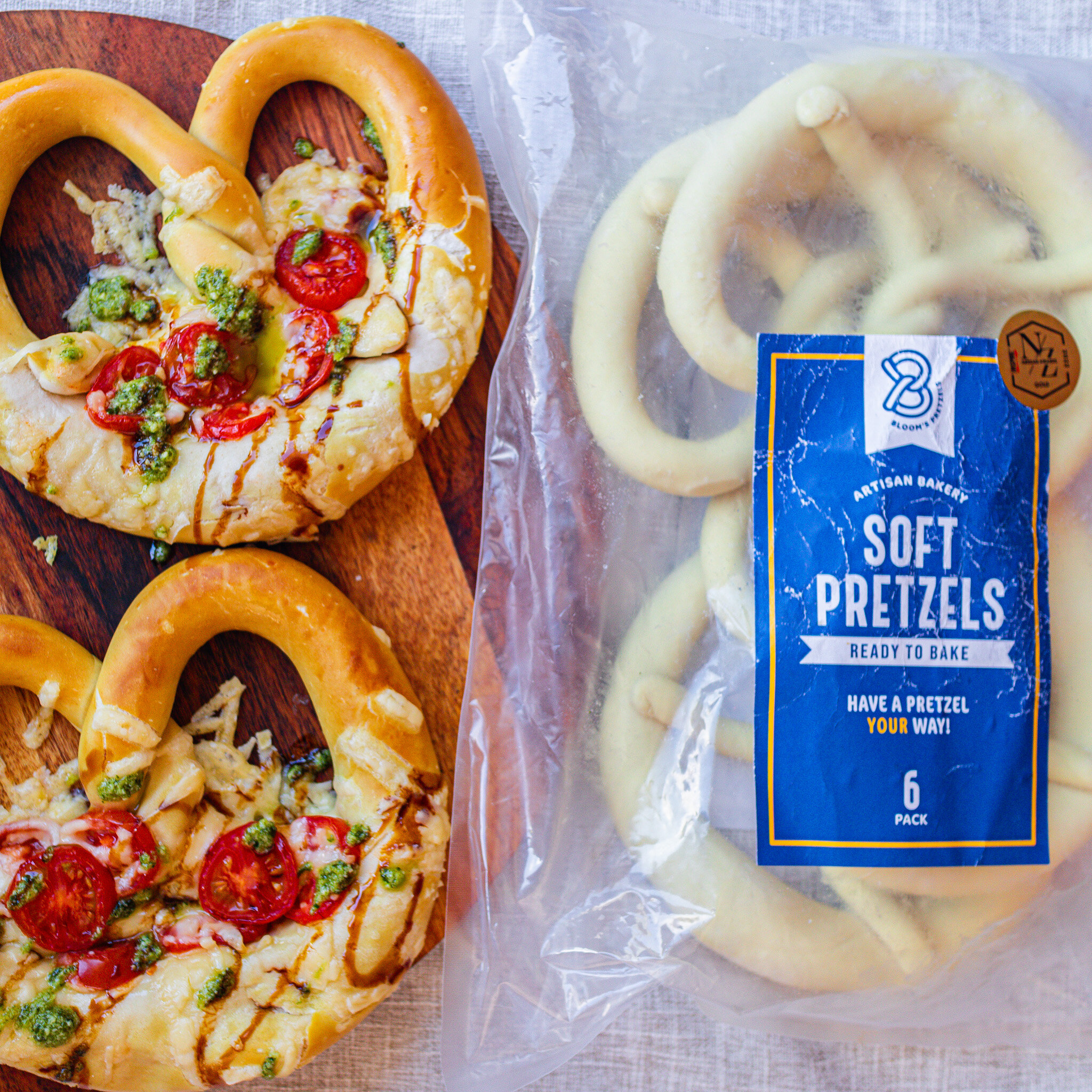 We've been fans of @bloomspretzelsnz soft pretzels for a long time, and now we can enjoy them in the comfort of our home with their Frozen 'Ready to Bake' 6-pack 🥨 We made some bruschetta-inspired pretzels using tomatoes, parmesan cheese, basil pest