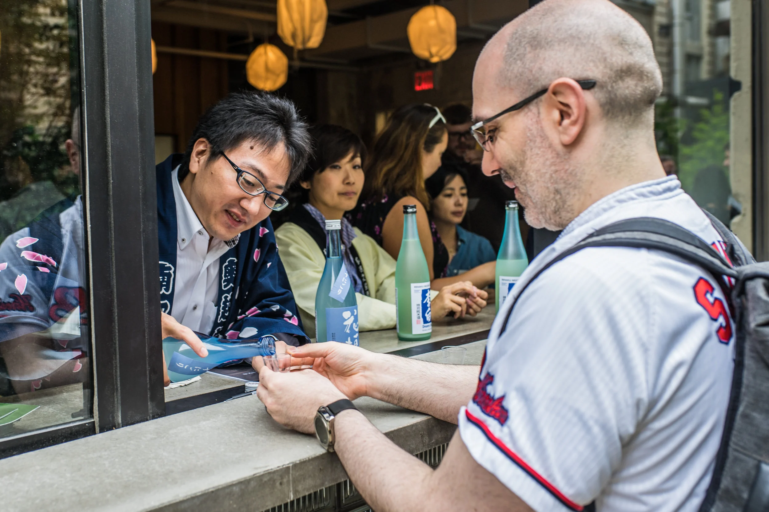 Nanbu Shuzo's Takuya Nambu pours John a taste of their excellent Hanagaki UsunigoriJunmai Daiginjo.