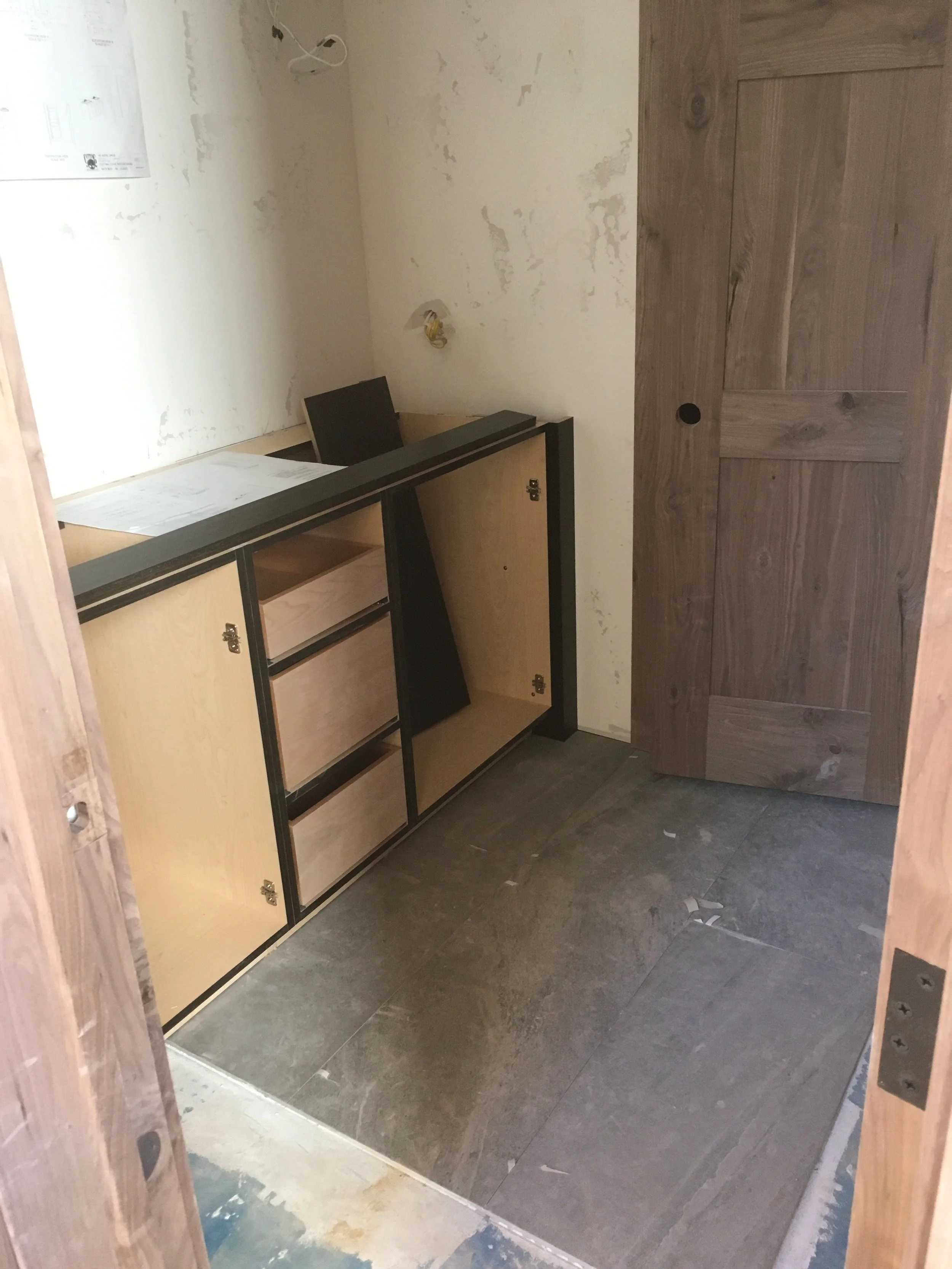 The main guest room with door, floor, and cabinets in place.