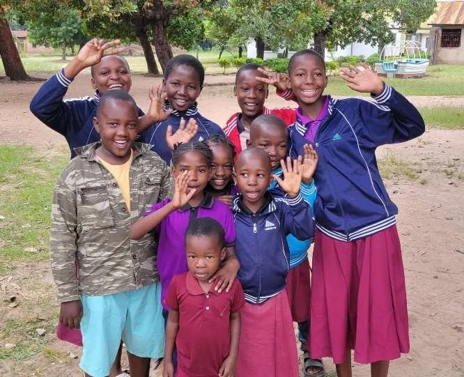 children waving goodbye