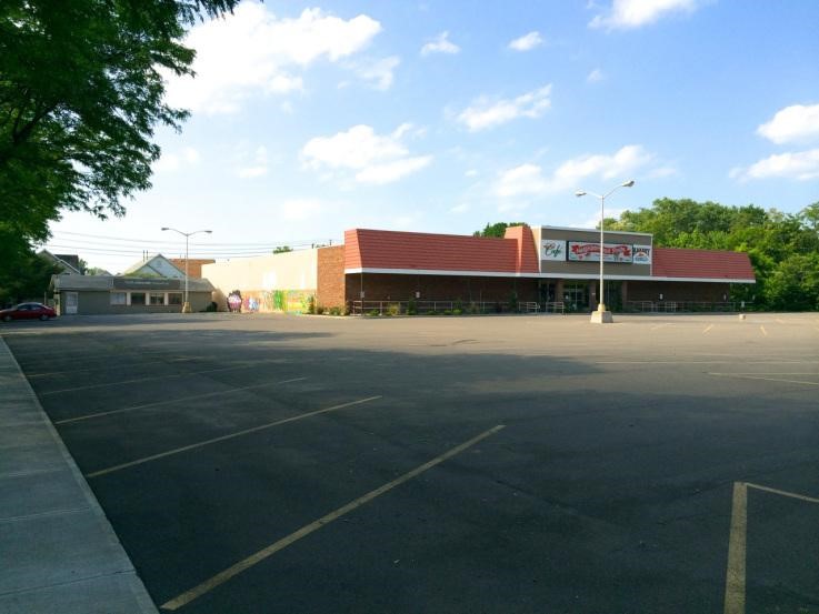 Project site before with abandoned store and parking lot