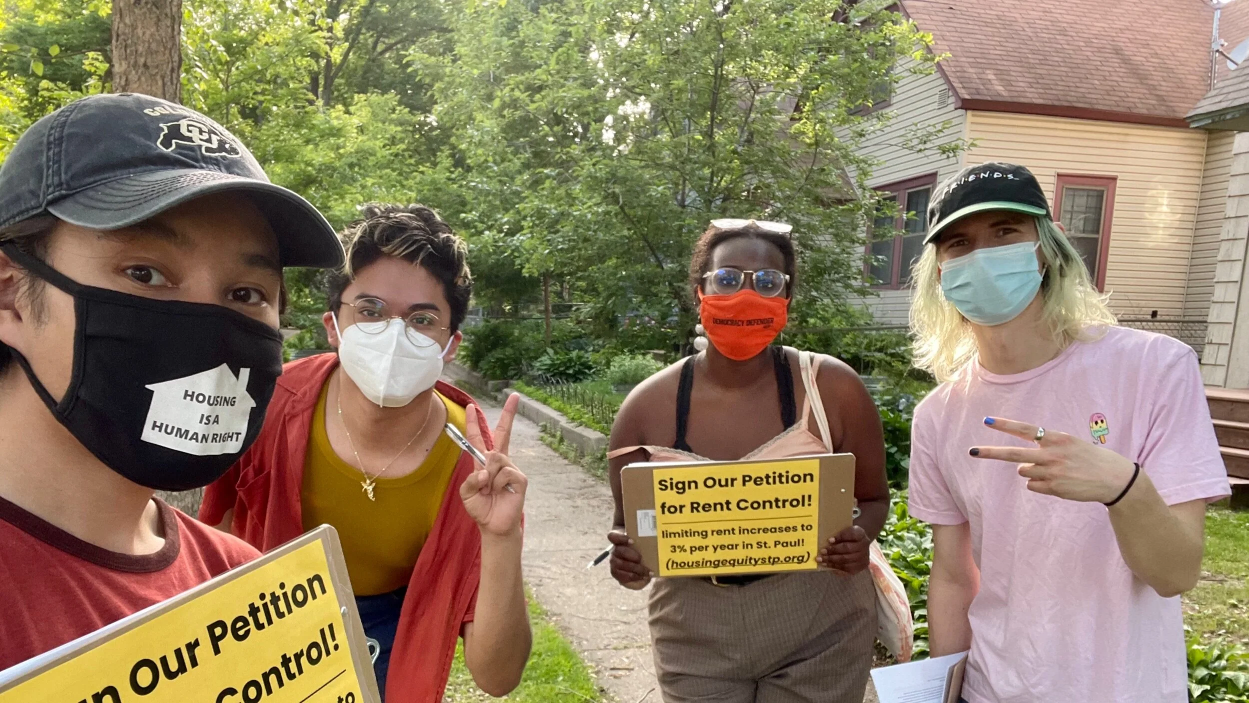 A group of young people wearing masks are ready to knock on doors in St. Paul to share information on the HENS campaign.