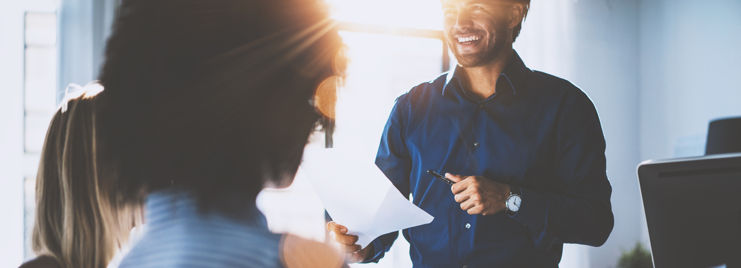 man smiling giving a presentation.png