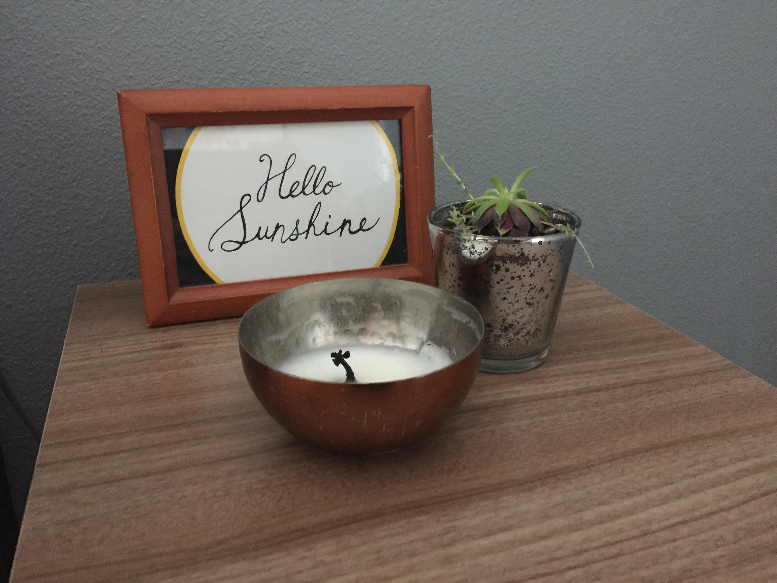 Three accessories. Three different items (artwork, plant, candle). Three heights.
