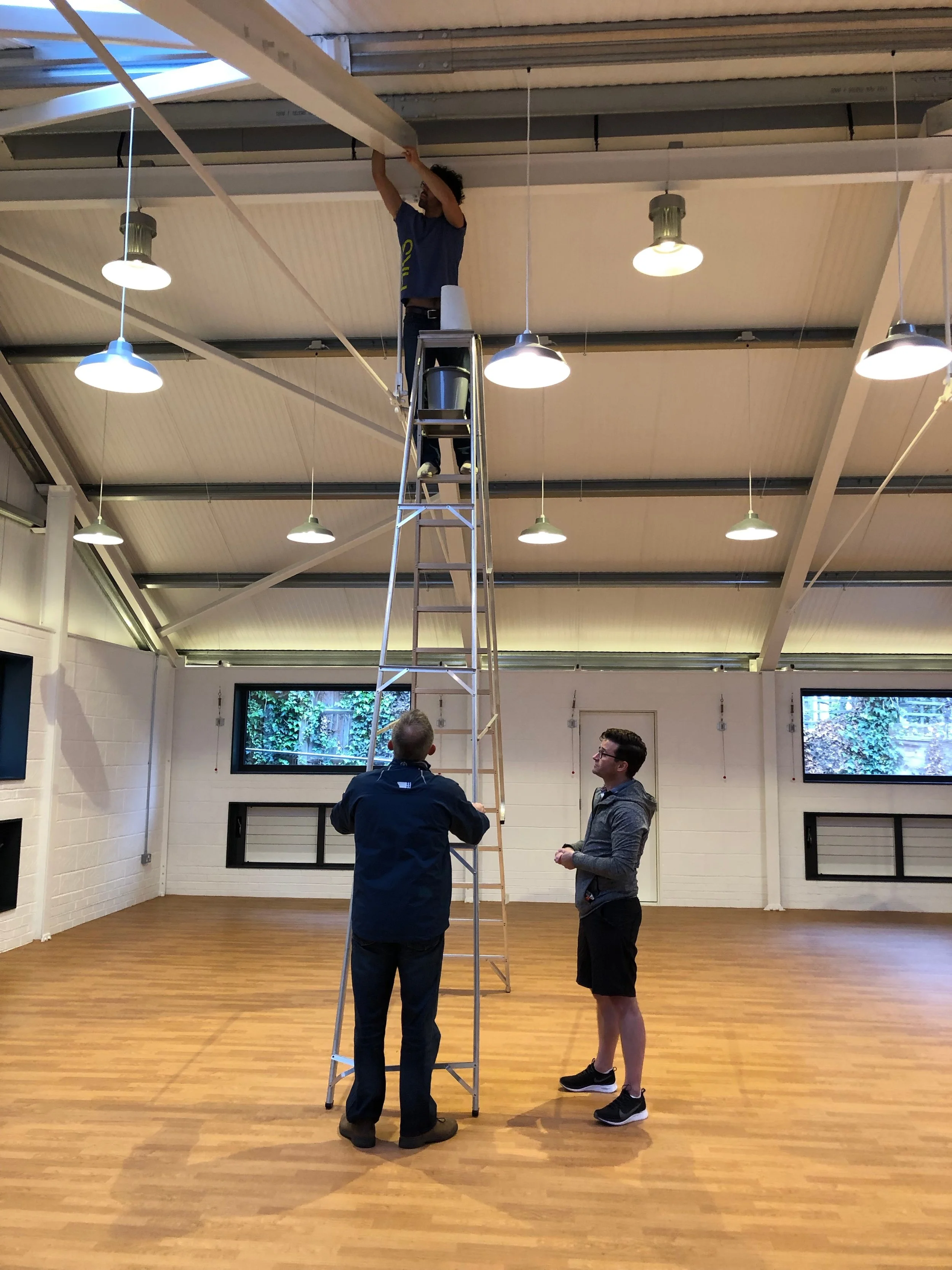 Luis Orozco is sent to the very top of the roof apex by Simon Harris (ladder safety man) as Jason Gray instructs…