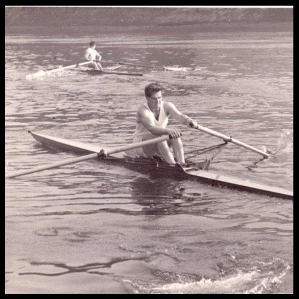 John Russell, foreground, competing in the Wingfield Sculls in 1959 in London colours. He overhauled the leader above Barnes Railway Bridge to win the race. Note the impressive puddle!
