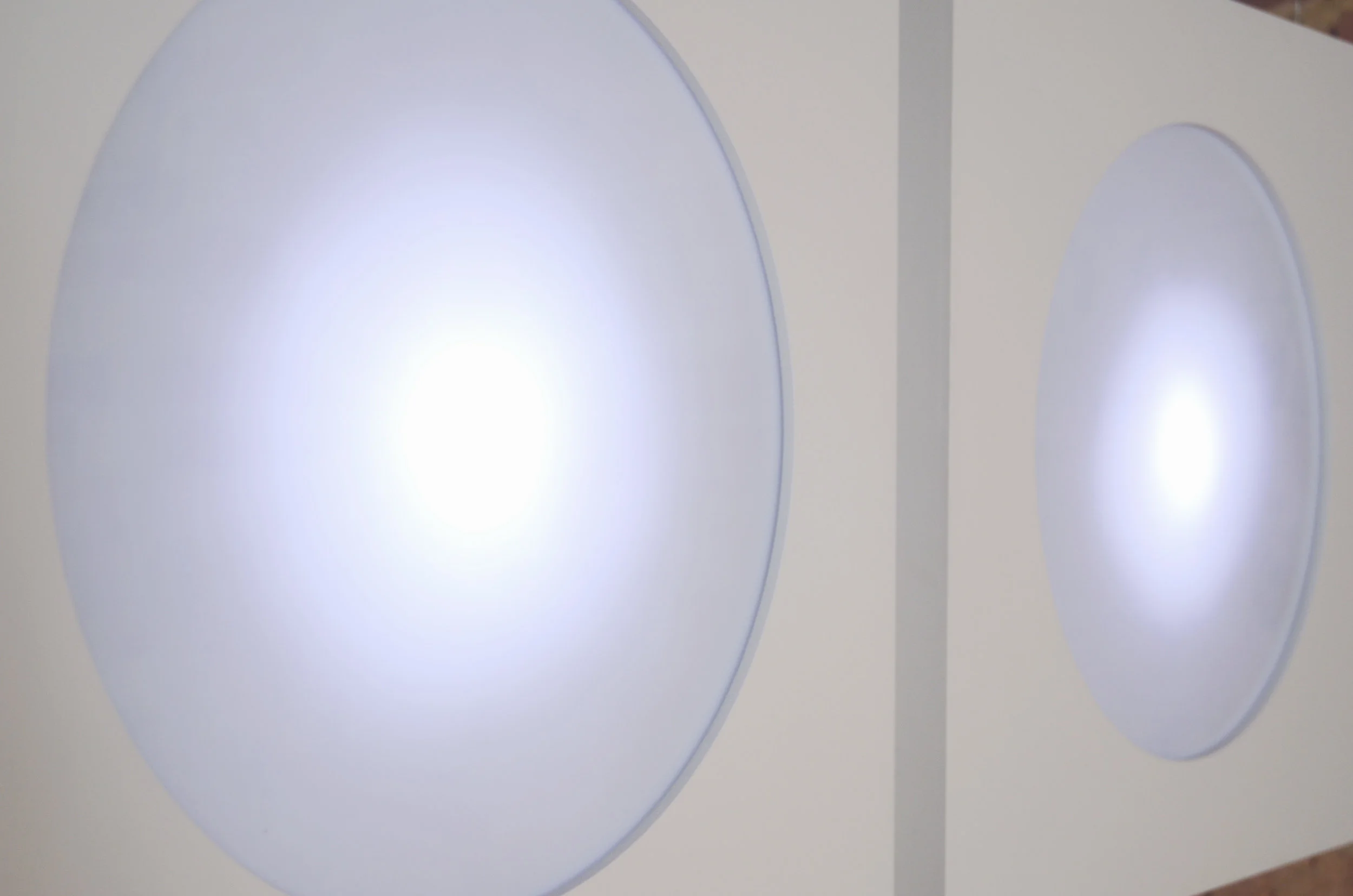 'Hello' consists of two robotic animated lightboxes that explore the relationship between people, place and light. 'Hello' is a portrait that depicts no trace of a human body or face, rather it is suggested, or ‘simulated’ through the rounded aperture through which the light emits. Taking this simulation further, and in a way to amplify the humanoid qualities of the piece, I programmed morse-code into the light boxes, so that each one attempts to communicate to the other and also to the audience.