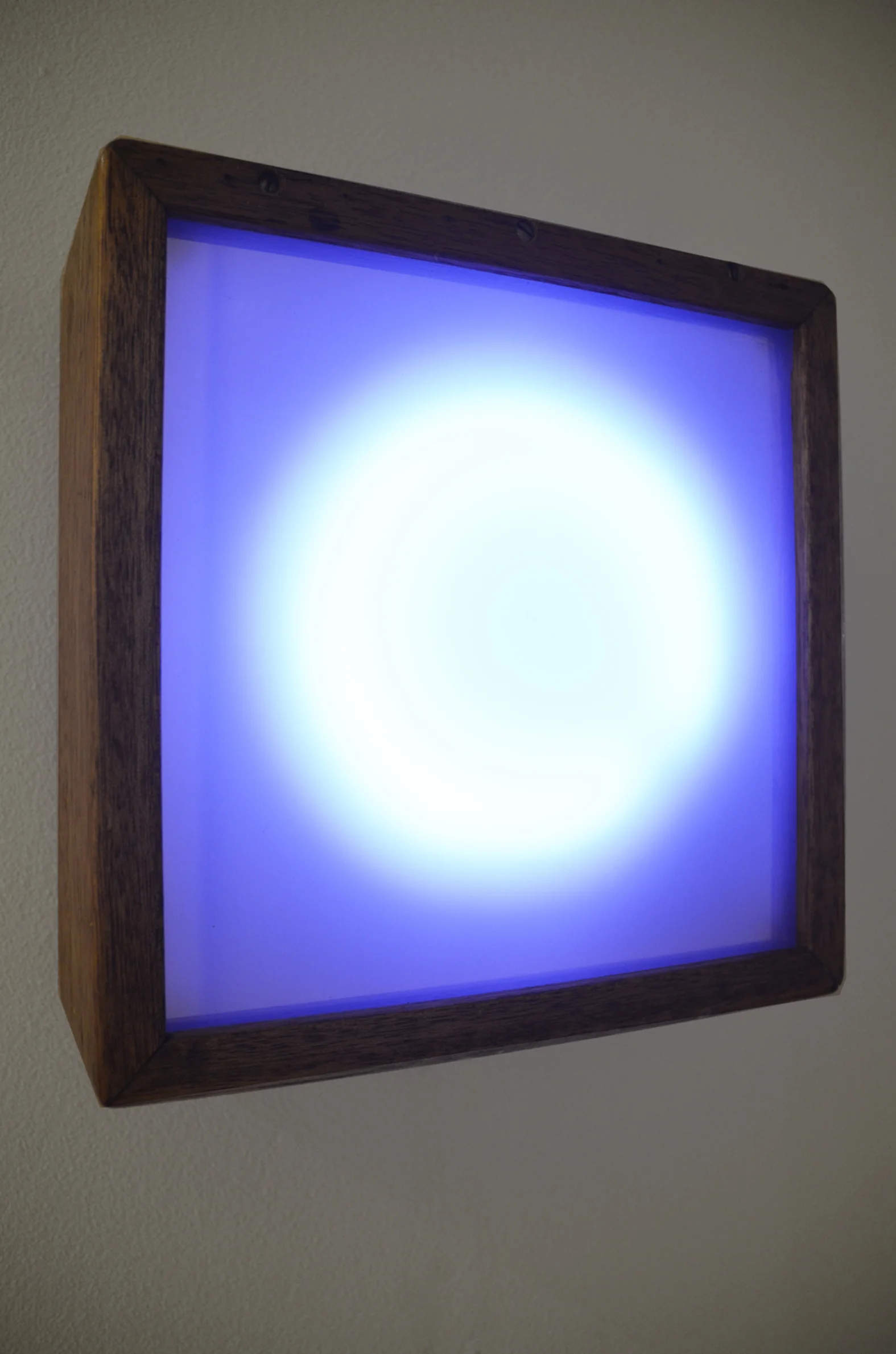 Echo is a work that acts as a disobedient mirror and an unreliable portrait. Through simple programming and a microprocessor embedded in the work, Echo alternates between being a reflective mirrored surface in which viewers can locate themselves, to a beaming light portal, where all reflection is lost. The circle of light that emanates from the work is a reductive ‘portrait’ that comments on the likenesses and connections between the human and the humanoid and seeing and being seen. Echo continues my interest in pushing at the boundaries of portraiture and exploring the evolution of the notions of ‘being’ and ‘presence’ as influenced by evolving technological heterotopias. Portraiture, as a mode of art making, is reflective of the changing notion of self through time, and Echo as a portrait addresses this in the age of the almost-ubiquitous selfie and the ever-increasing influence of online and virtual worlds.