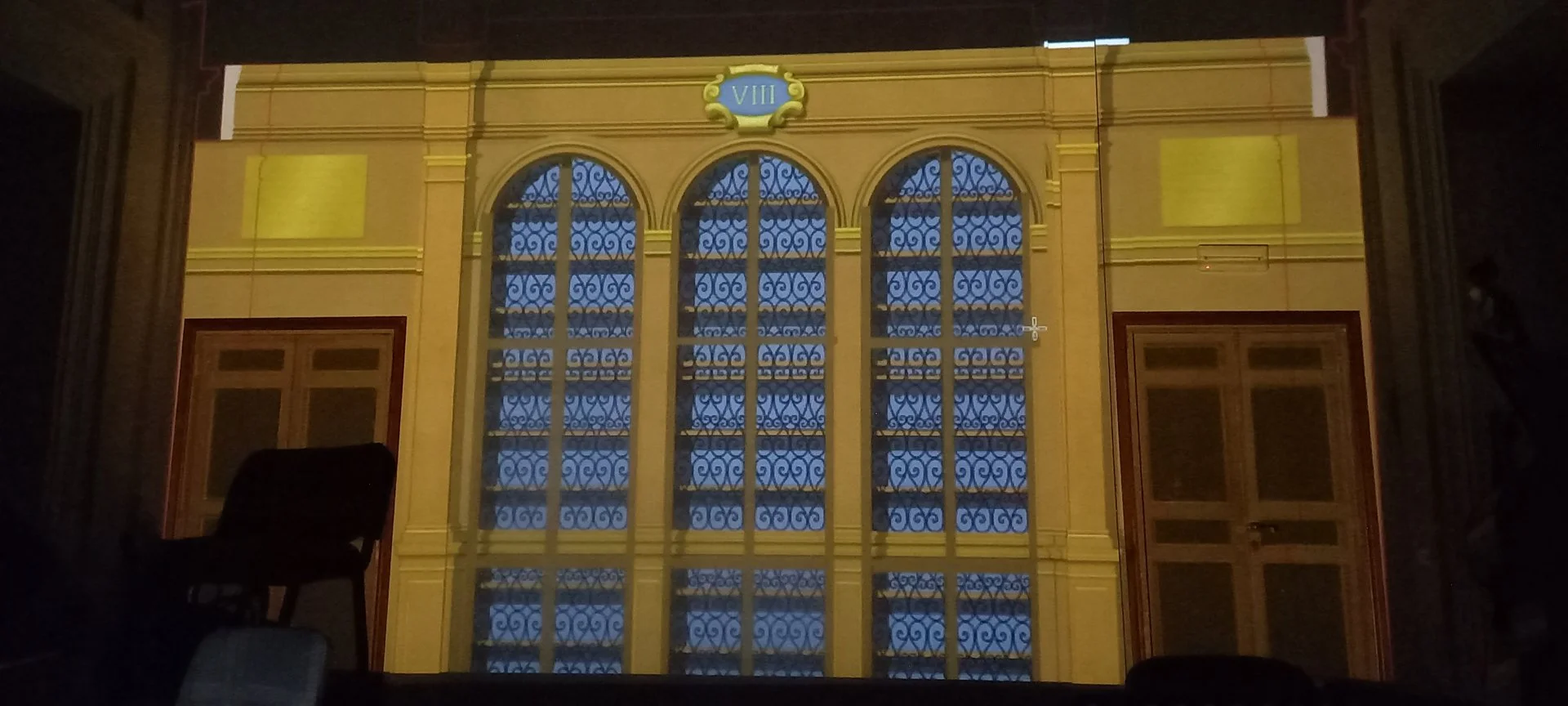  The library design was projected onto the actual walls of the hall to assess scale and proportions in situ, allowing for precise adjustments. 