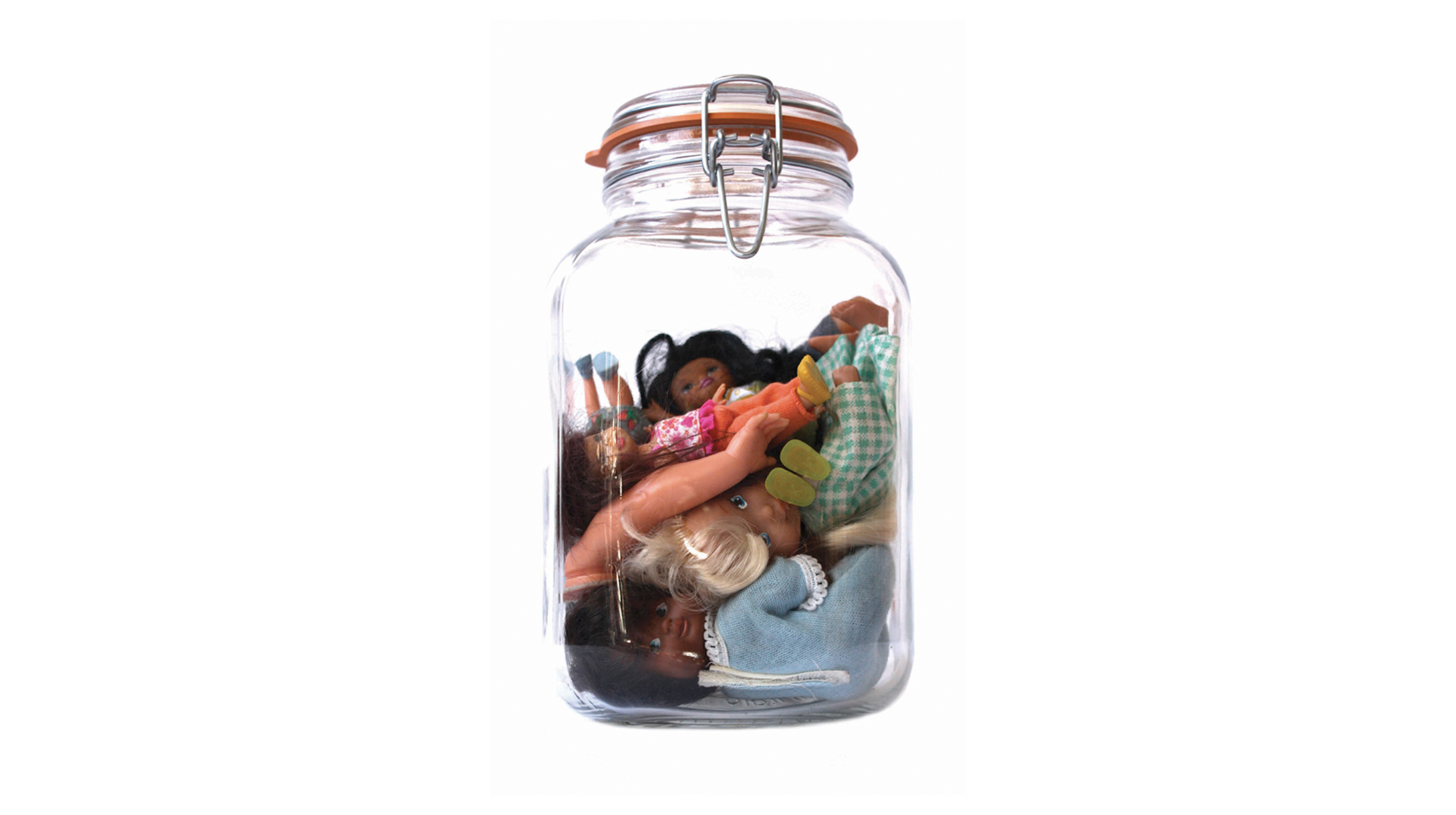photograph of a glass mason jar with a bunch of dolls inside