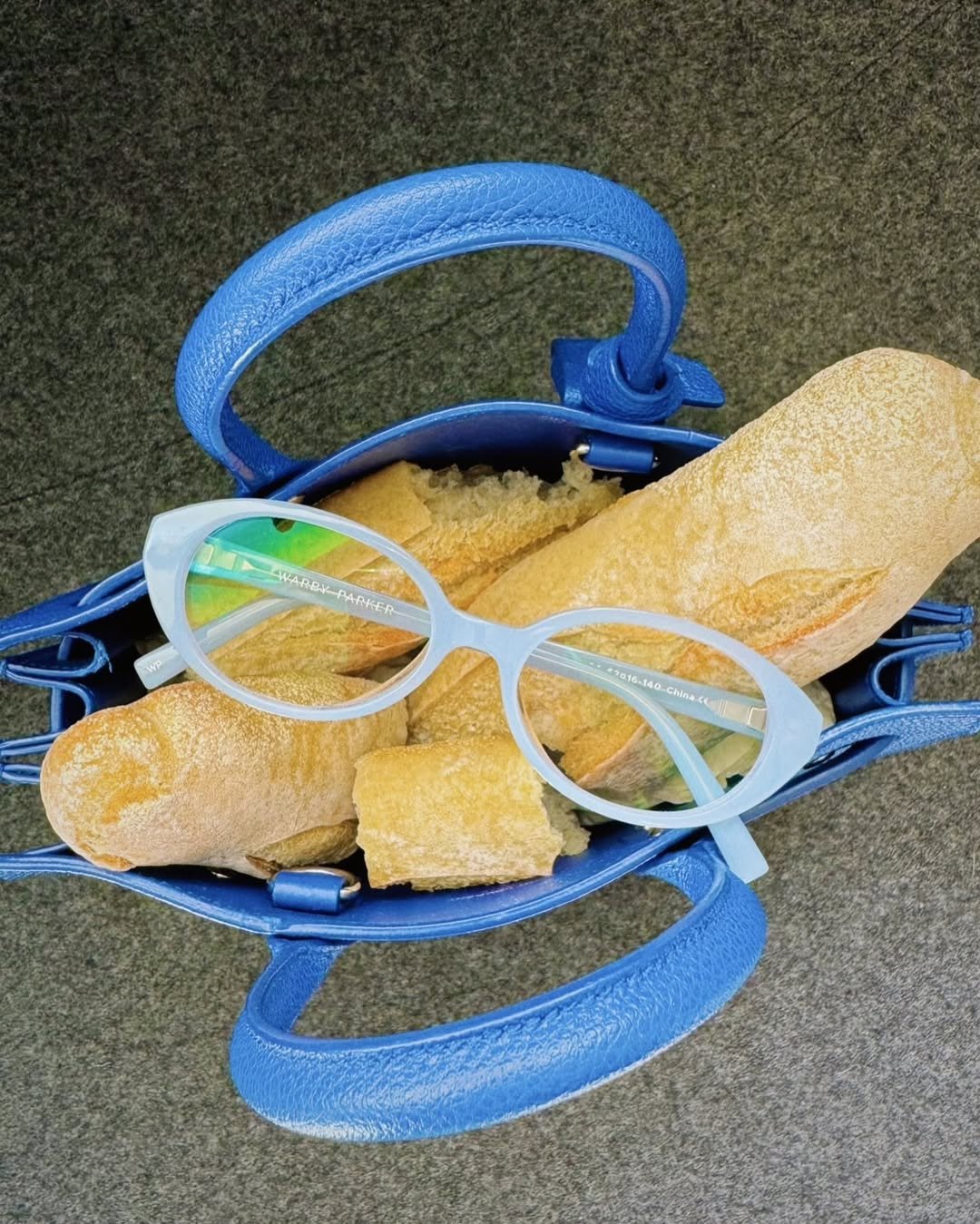 No summer ensemble is complete without a bold pop of color&mdash;and these @warbyparker specs have us swooning! 👓 Pair with your favorite accessories (baguette in tow 🥖), and you have a chic, cheeky, color-coordinated look to savor all season long.