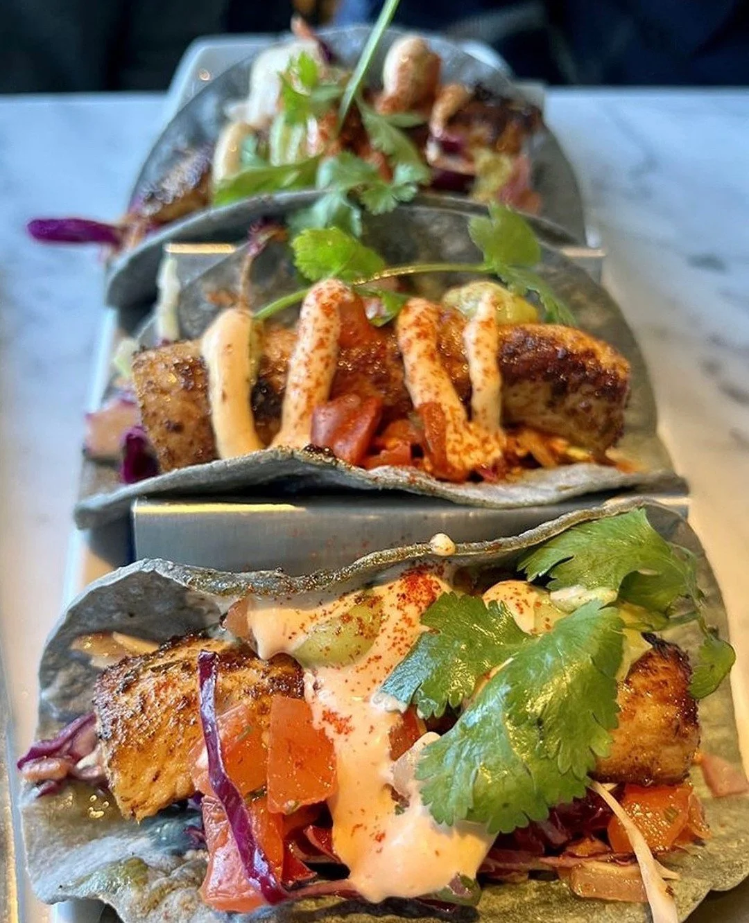 Weekend cravings curbed in delicious style thanks to @cov_restaurants' Mahi Fish Tacos! 🌮 Featuring grilled or fried mahi, fresh pico de gallo, creamy avocado and a kick of adobo chili aioli, this dish brings all the flavor your Friday deserves. Ava