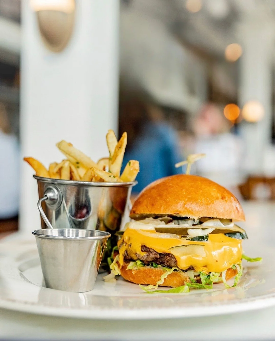 A classic, elevated. 🍔 @cov_restaurants&rsquo; signature CōV Burger features hand-ground Sakura Wagyu, local butter lettuce, American cheese, Creole mustard aioli, and house pickles. We suggest pairing with fan-favorite truffle fries for a dinner du