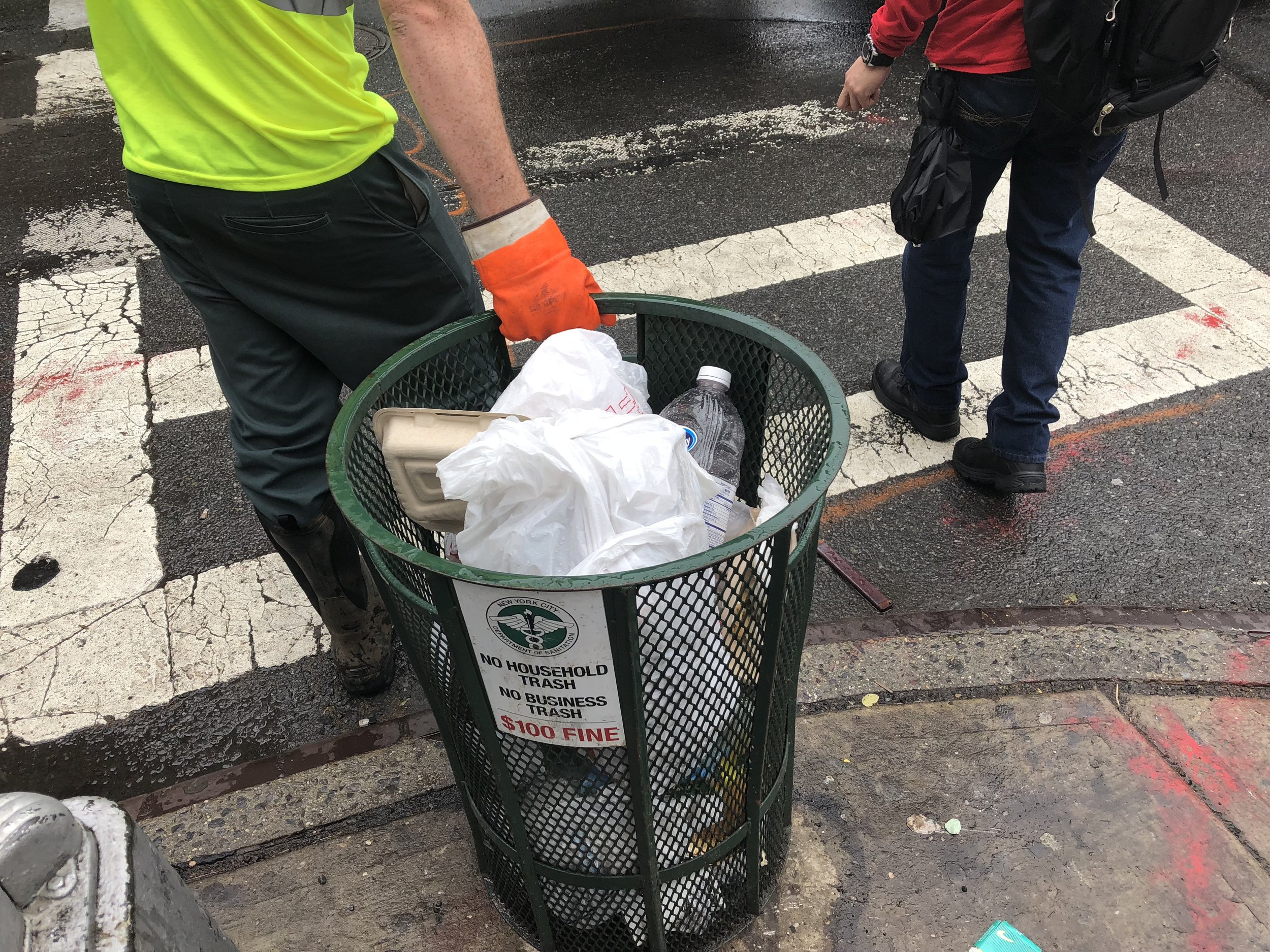 Sanitation Worker services a basket on 6th Avenue. Photo by Van Alen Institute.
