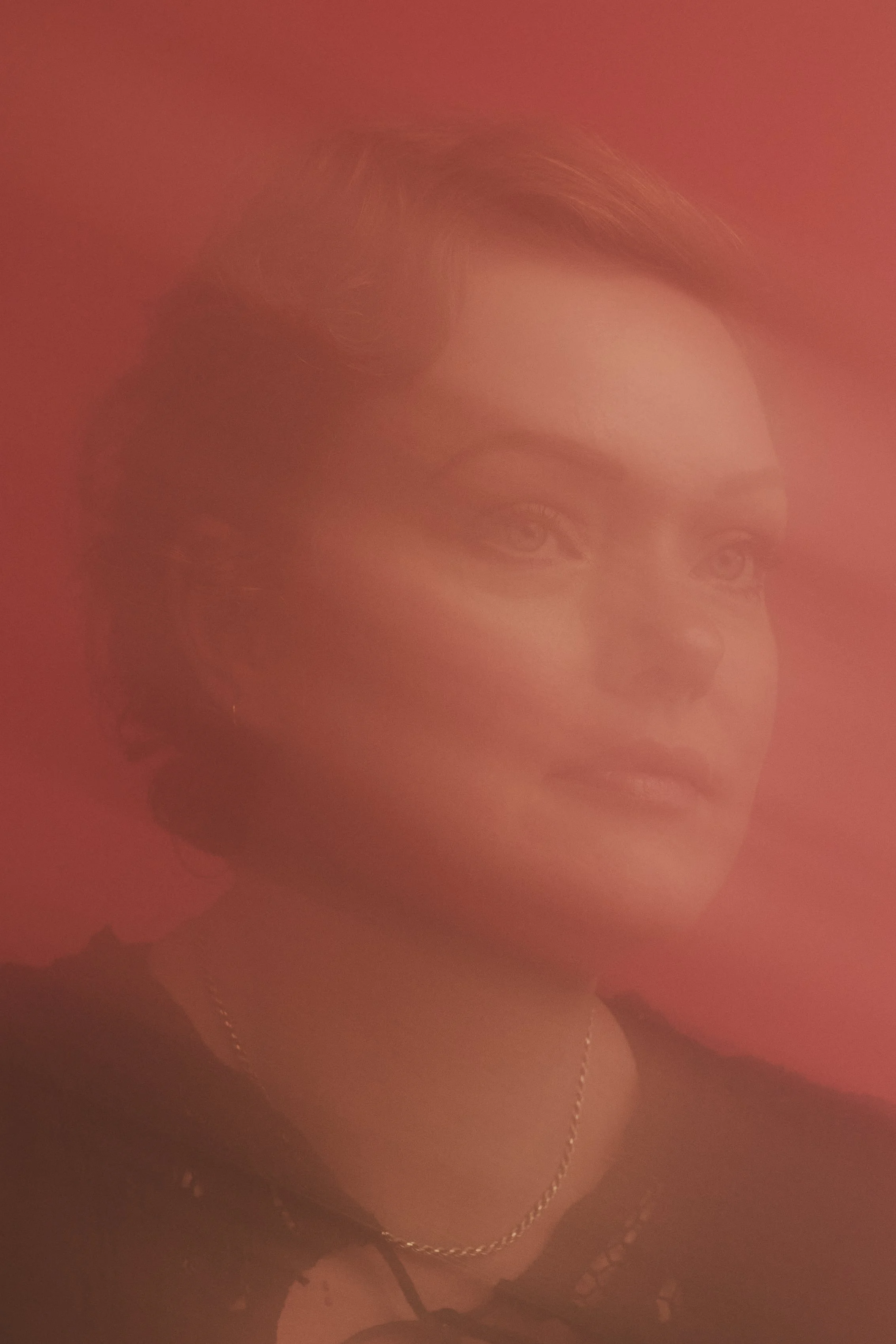 Close up portrait of author with red background
