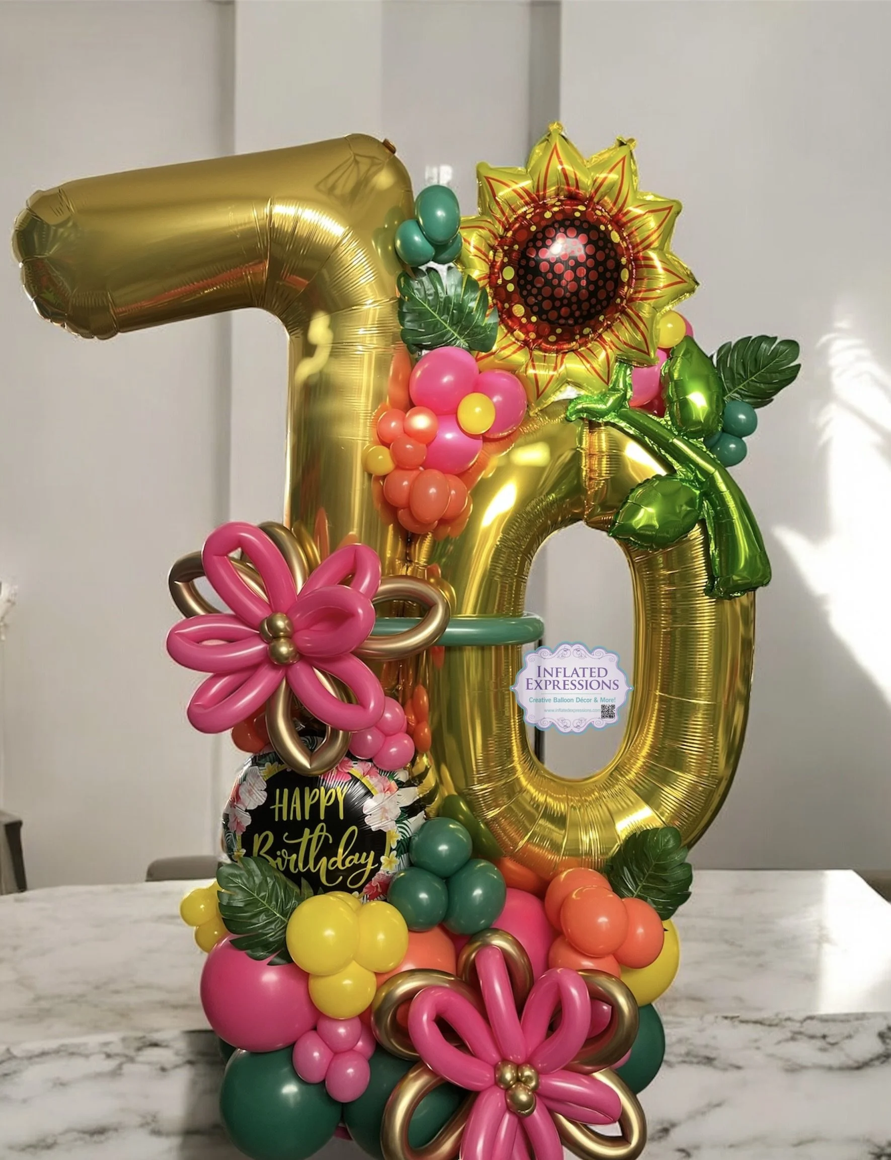 Tropical inspired birthday balloon bouquet with sunflowers and hibiscus, handcrafted by Inflated Expressions in Riverview, Florida.
