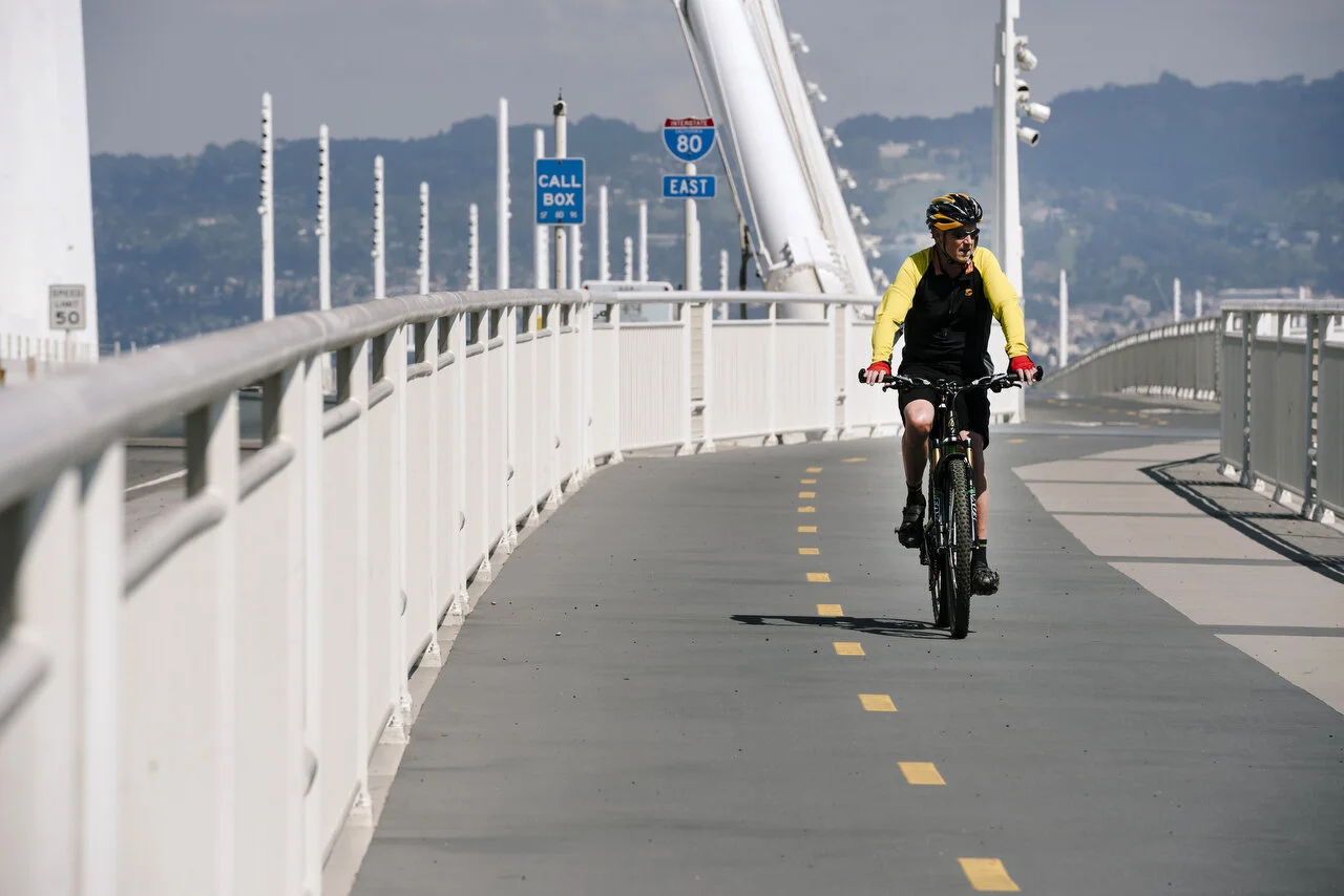  A lone cyclist on the Bay Bridge in San Francisco , following a shelter-in-place order made by the mayor, March, 2020,  For Bloomberg. 