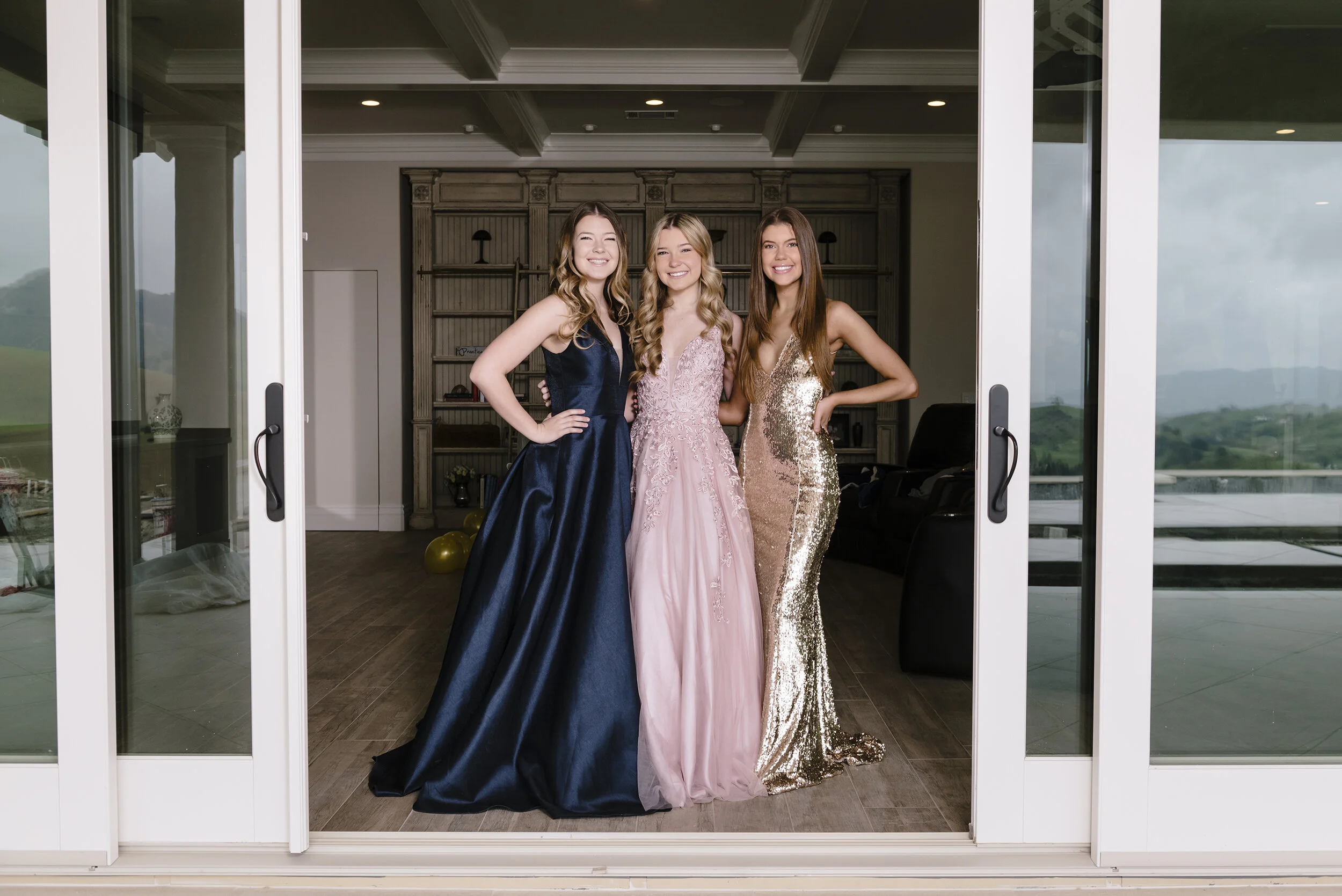  Twins Brook Reese, left, and Natalie Reese, and their sister Allison Reese, stand for a portrait in their prom dresses before the family films TikTok videos of themselves celebrating the girls' canceled prom from their home in Danville, Calif, on Sa