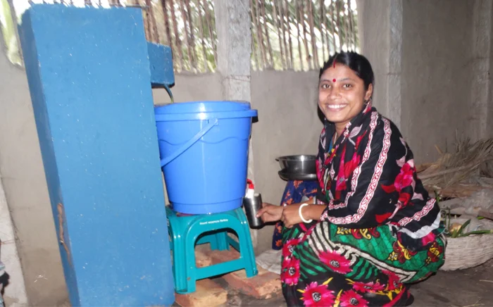 Suchitra Sarder grabs a glass of clean water in her home in the rural village of Porakatla, Bangladesh. 