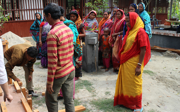 Filter recipients look on as the concrete filter is "de-molded" from its Wood Mold.