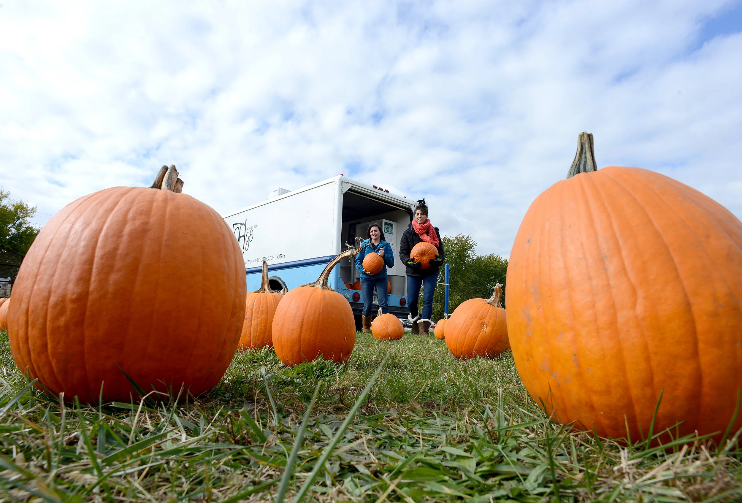  OHgo volunteers set out a mobile pumpkin patch at Furry Elementary in Perkins Township for kids to pick through on Tuesday, Oct. 31, 2017. 