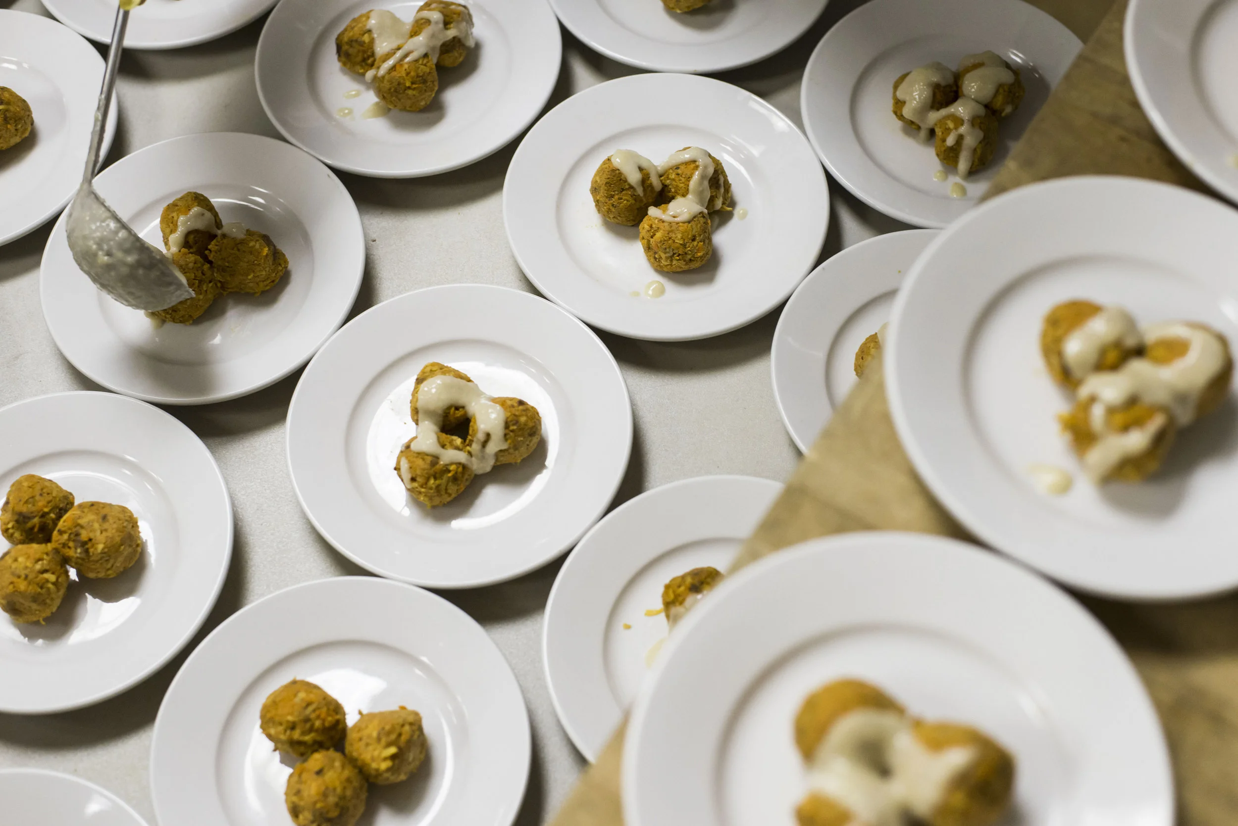  A volunteer plates one of the several courses during Community Food Initiative’s Harvest Dinner on Saturday, October 25, 2015 in Athens, Ohio.  