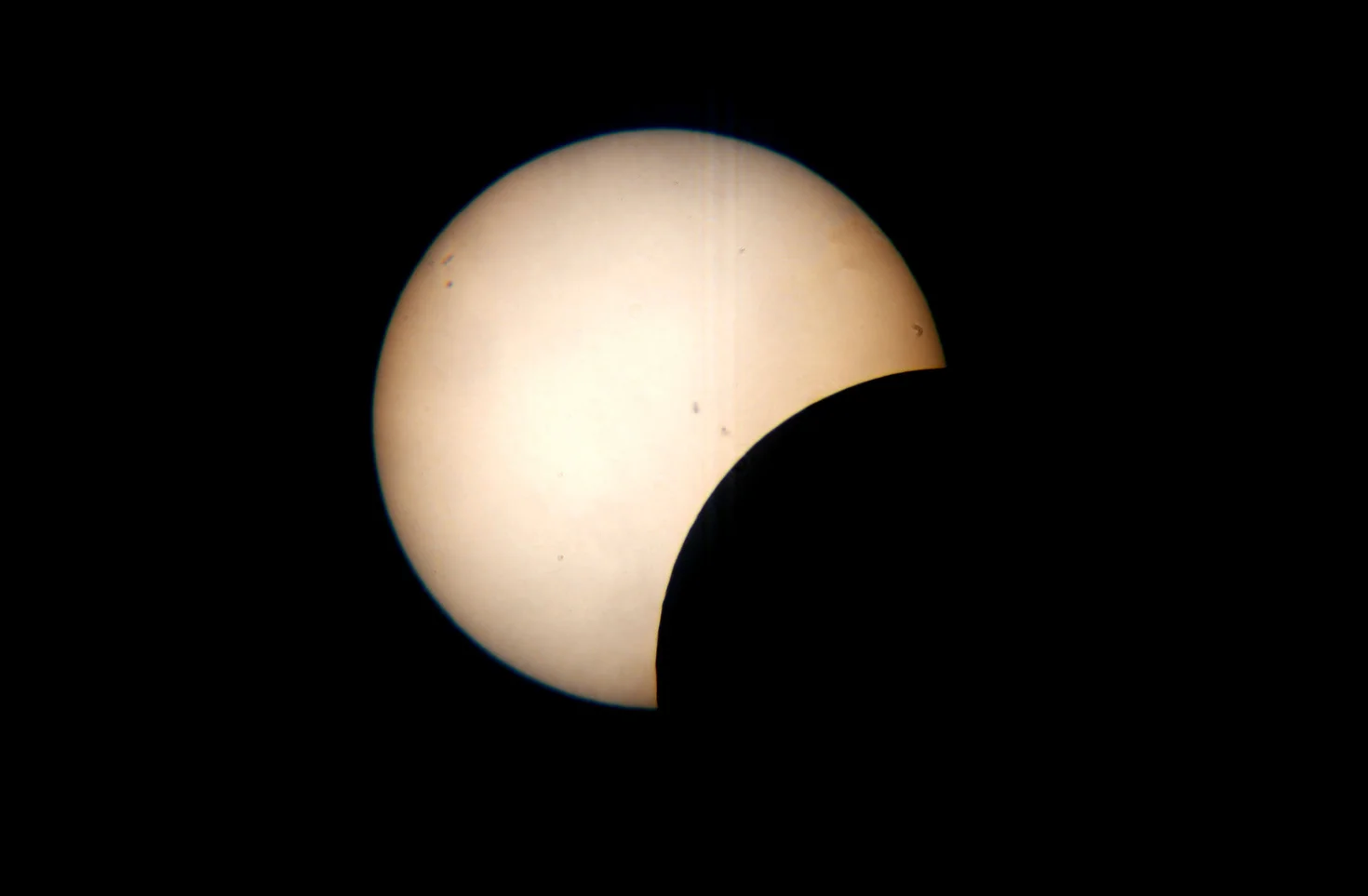  The moon starts to move across the path of the sun during the partial solar eclipse in Huron at 1:36 p.m. on Monday, August 21, 2017. 