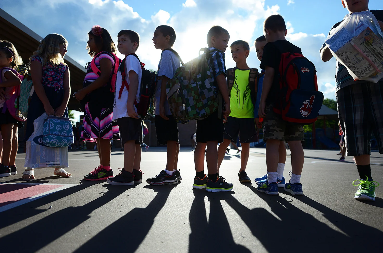  As the sun peaks out from behind clouds in Port Clinton on Monday, Aug. 22, 2016, Bataan Elementary School children line up for the first day of school. 