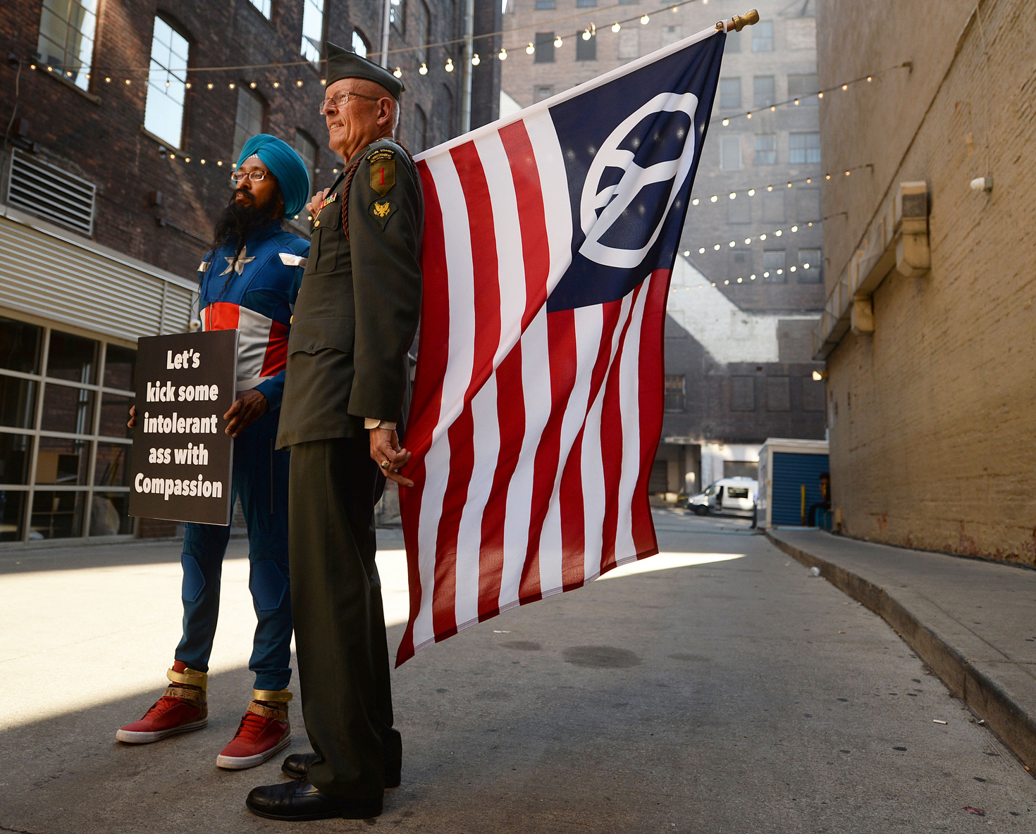  Two demonstrators stand together in an alley off of East 4th Street in Cleveland on Wednesday, July 20, 2016 during the Republican National Convention.  