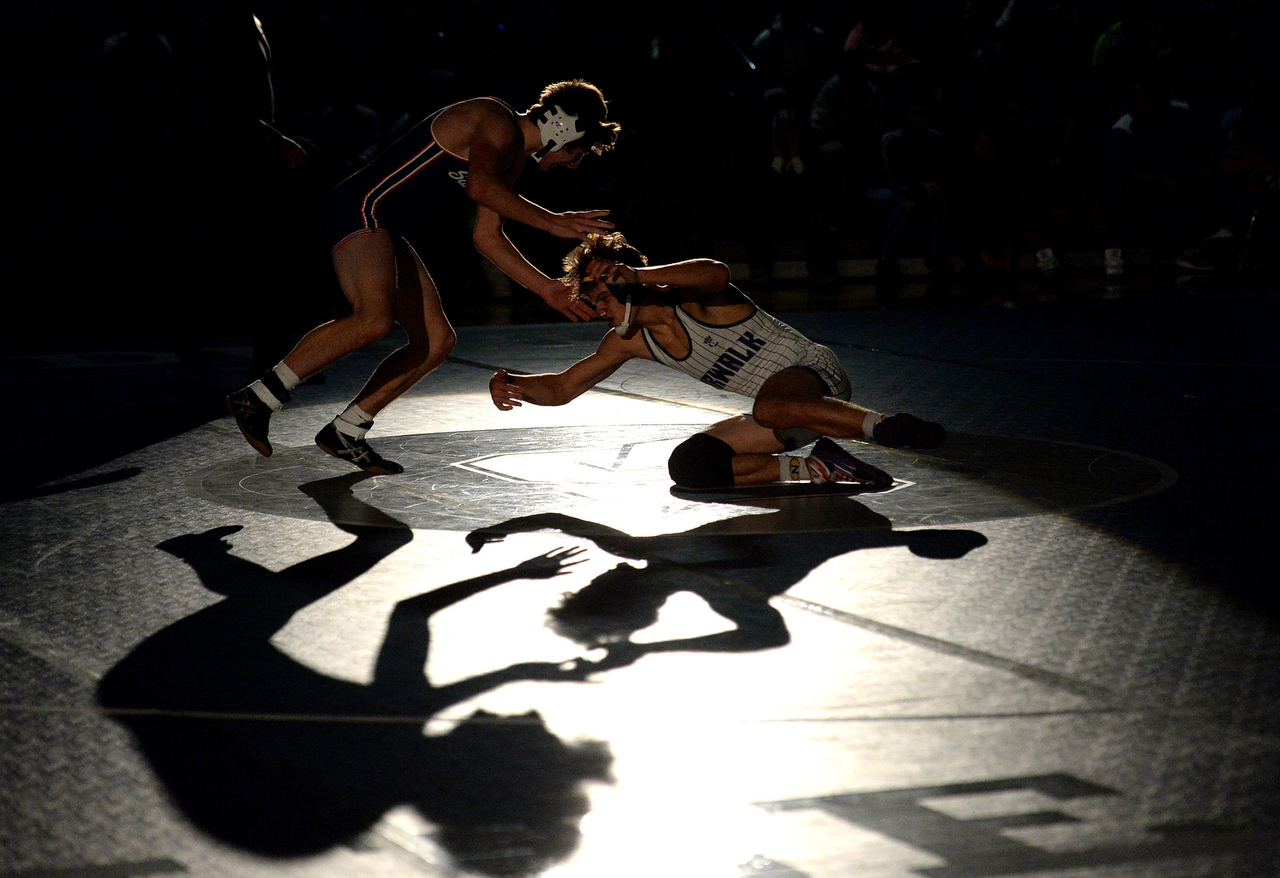  Sandusky's Vinny D'Amico defends a shot from Norwalk's Ethan Hernandez in the special lighting of the 2017 Odyssey matchup at Sandusky High School on Wednesday, Dec. 6, 2017. The Blue Streaks toped Norwalk 52-21 for the meet.  Best Sports Photo, fir