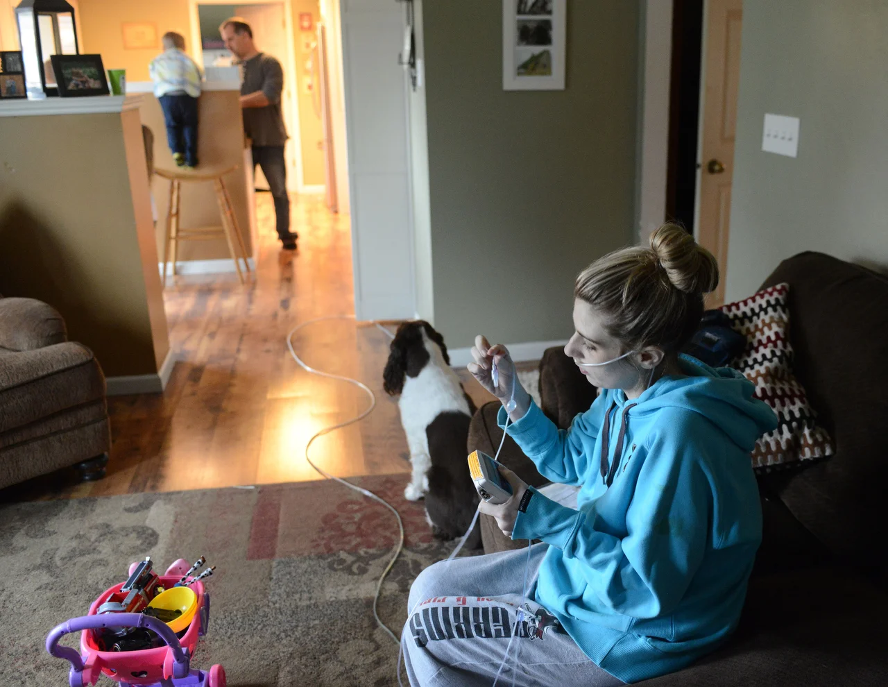  While her family prepares for dinner in the kitchen, Madison changes out the tubing to her hypertension medication. She only has mere minutes to replace her medication before it completely leaves her system, which causes an extreme form of withdrawa