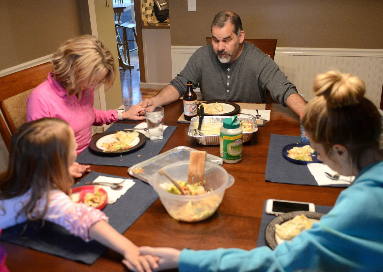  Matt Brenton, Madison's father, says a prayer before family dinner on Thursday, March 30, 2017 