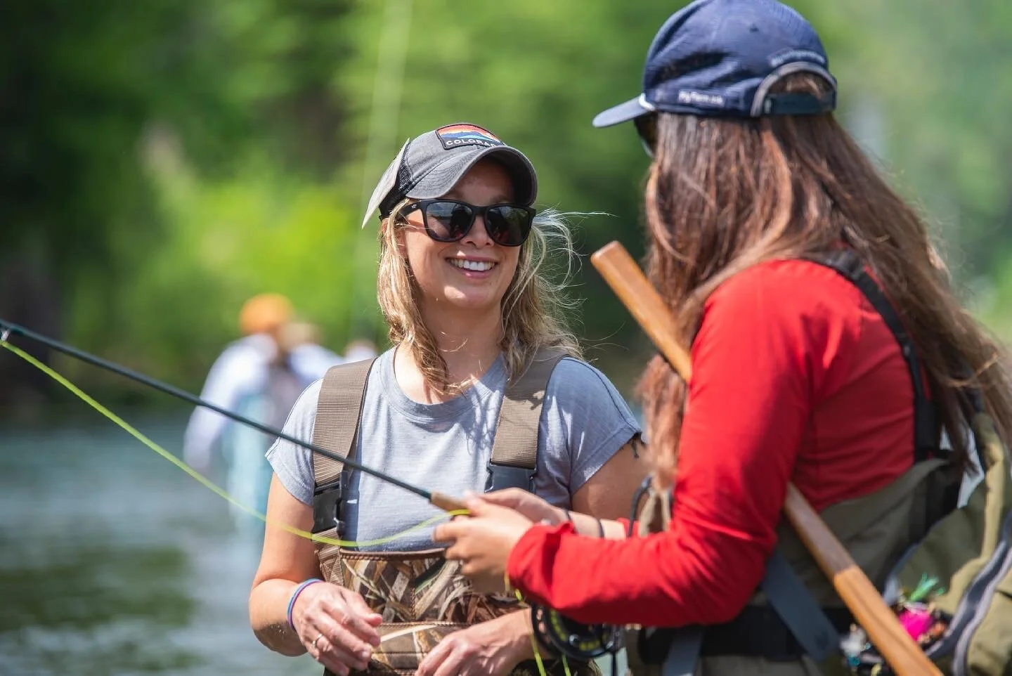  Fly fishing guide Christa Miriashtiani helps a guest during a Women’s Introduction to Fly Fishing clinic. 