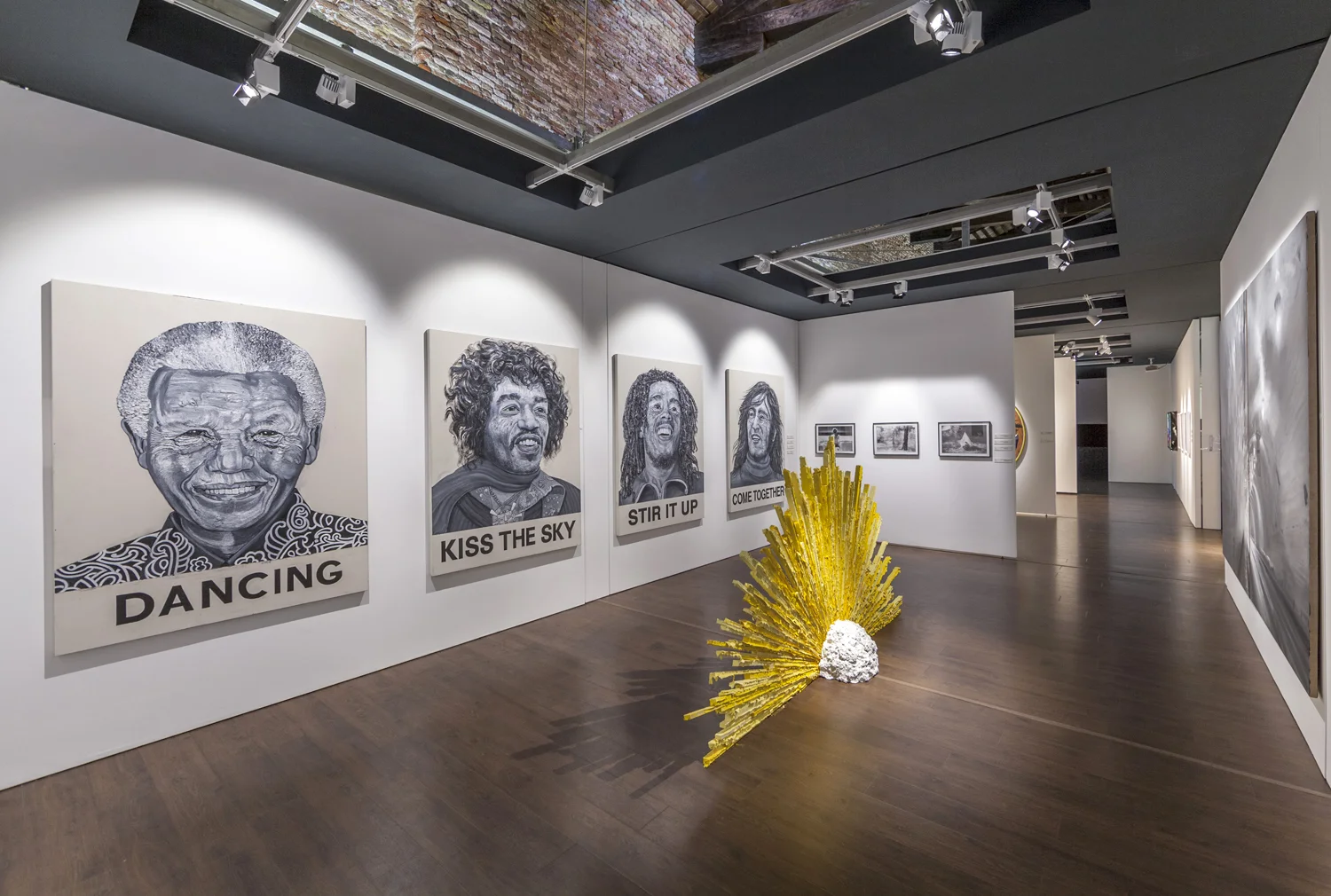 Robbie Conal [left, paintings]. Jamison Carter [center, sculpture]. Brandy Eve Allen [right, photographs]. Frank Ryan [far right, paintings].