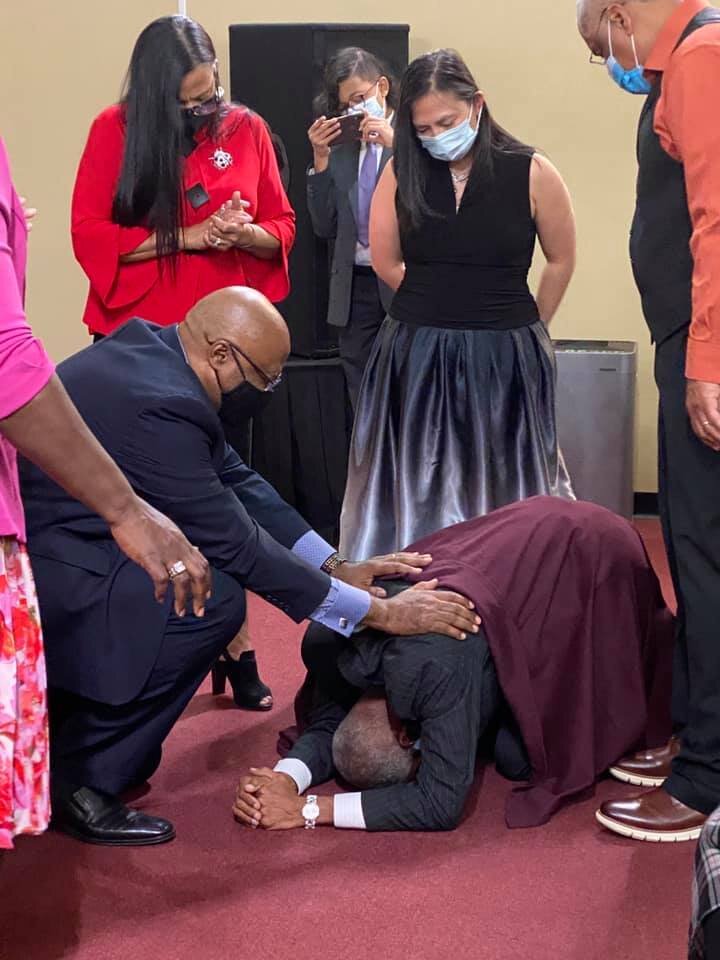NHIM Bishop praying for Dr Leak.jpg