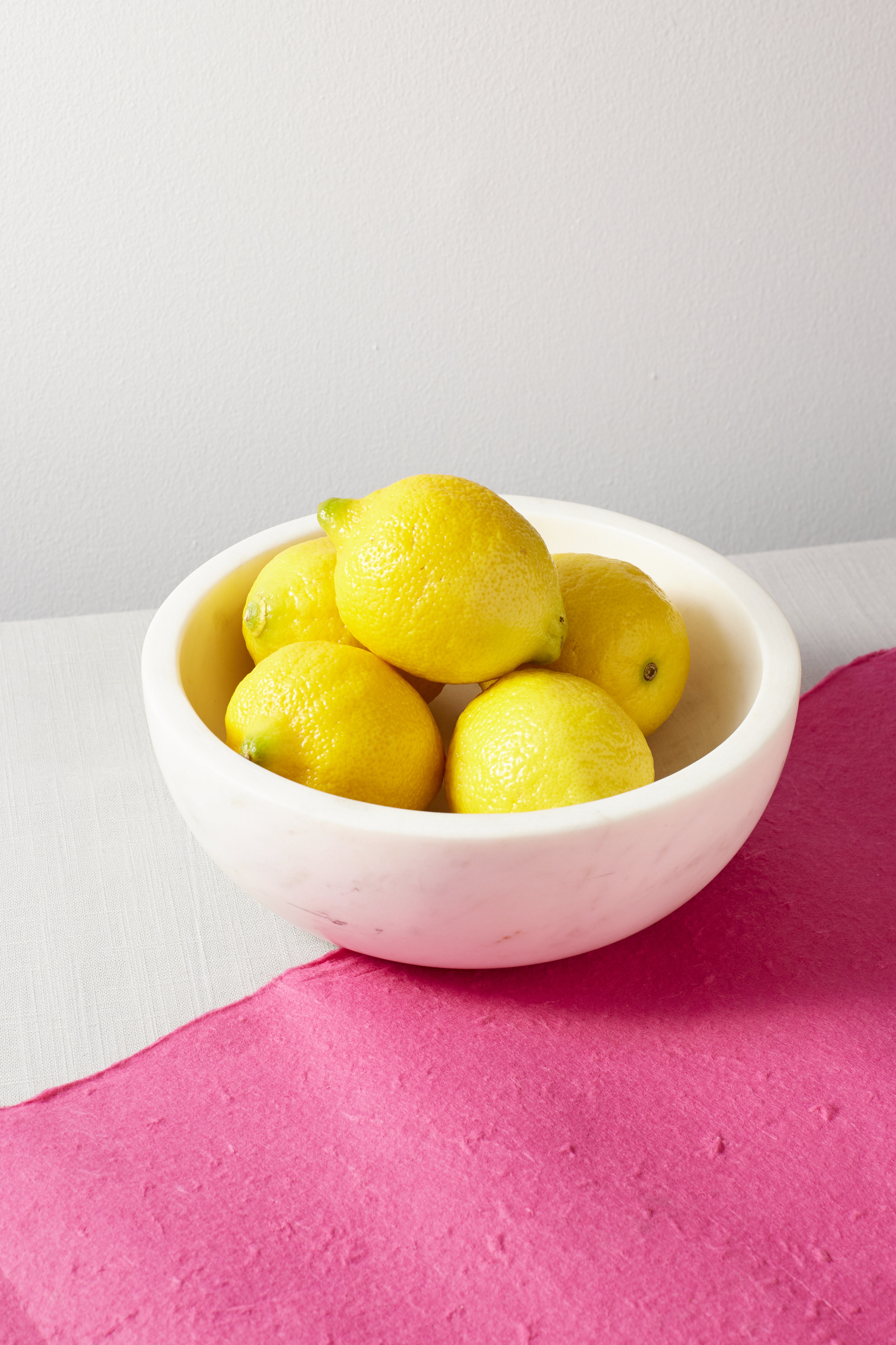 Lemons in marble bowl