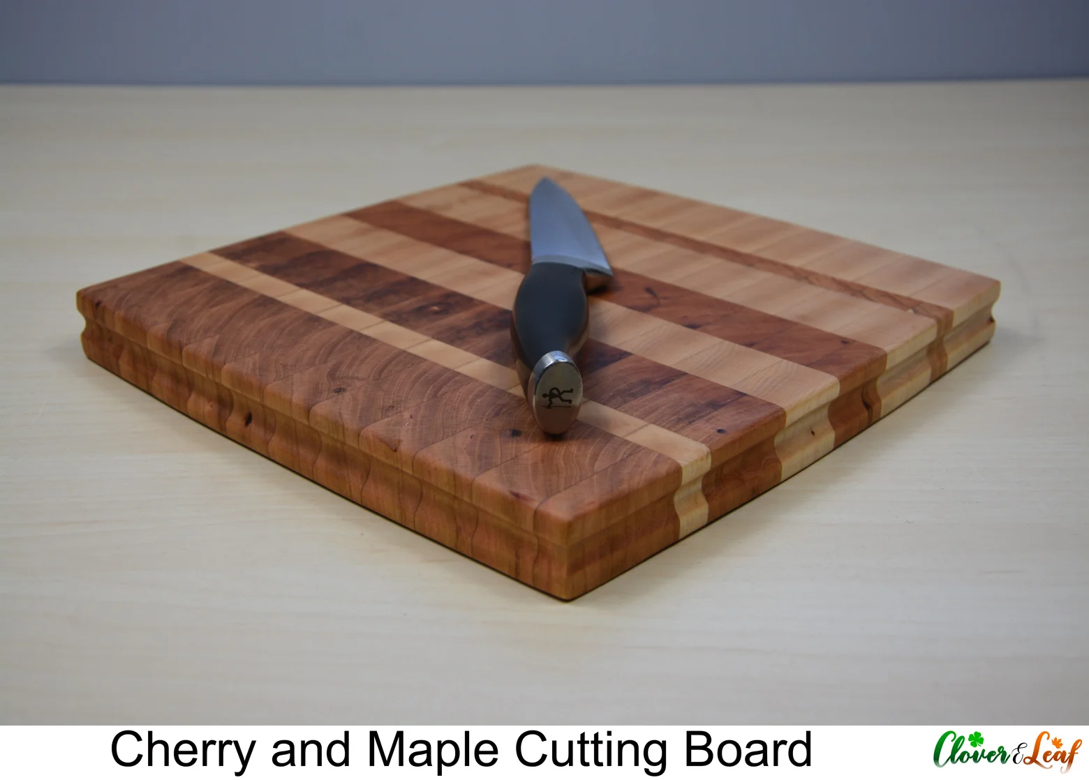 Cherry and Walnut Cutting Board Side with Knife.jpg