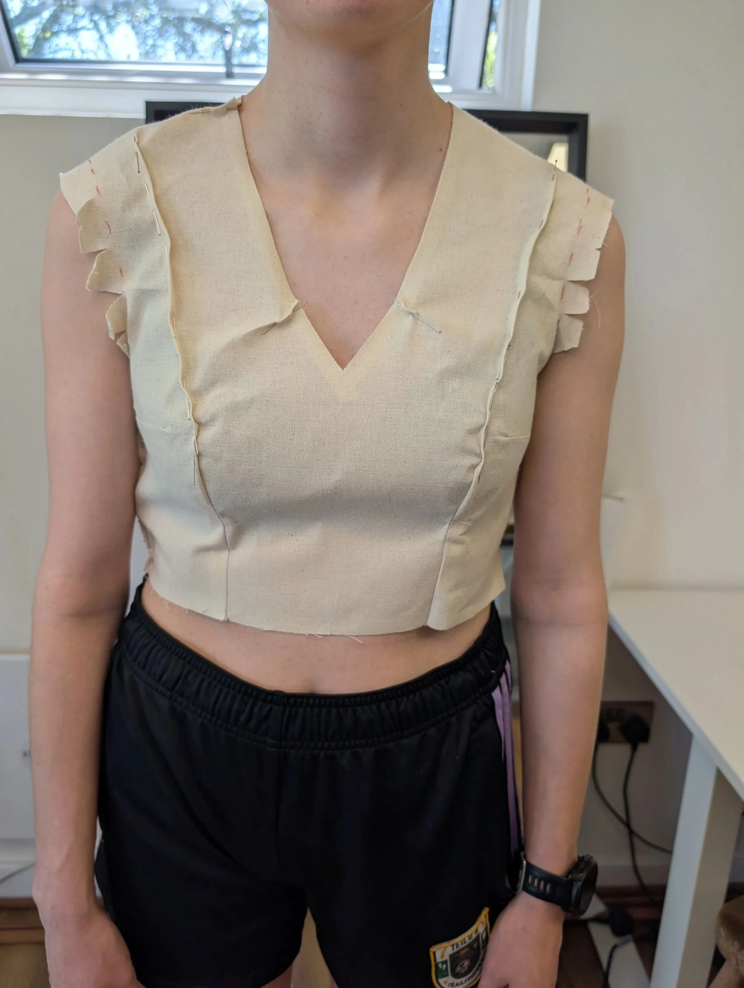 2. The calico toile after fitting. Darts have been changed to princess seams, V-neck has been cut in, neckling has been pinched where it was gaping